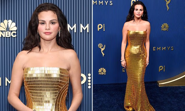 Selena Gomez wearing a glittering gold gown and long hair extensions on the Emmy Awards red carpet