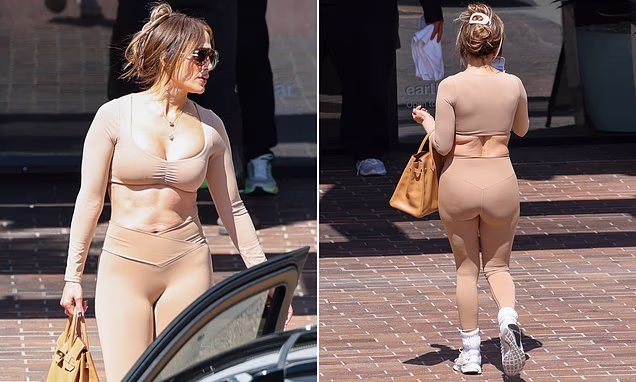 Jennifer Lopez wearing a nude crop top and leggings while carrying a Birkin bag to the gym