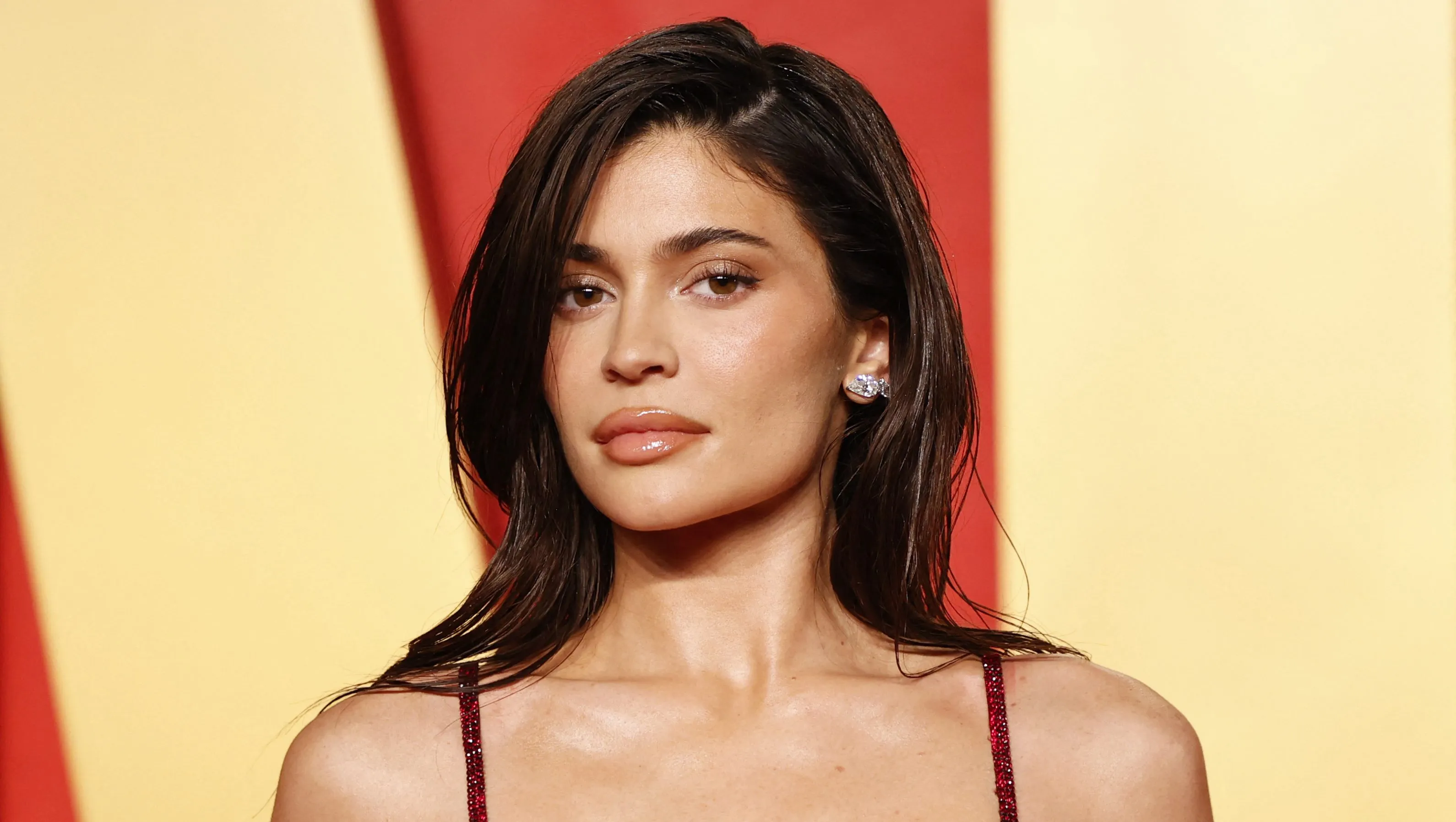 Kylie Jenner posing on a red carpet in a glam dress