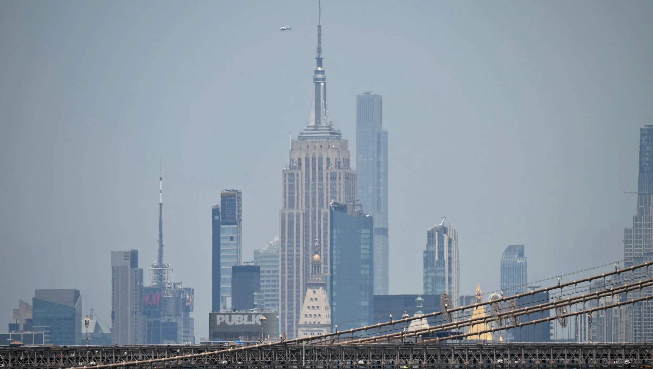 Angela Nikolau and Ivan Kuznetsov performing a stunt atop a high-rise structure