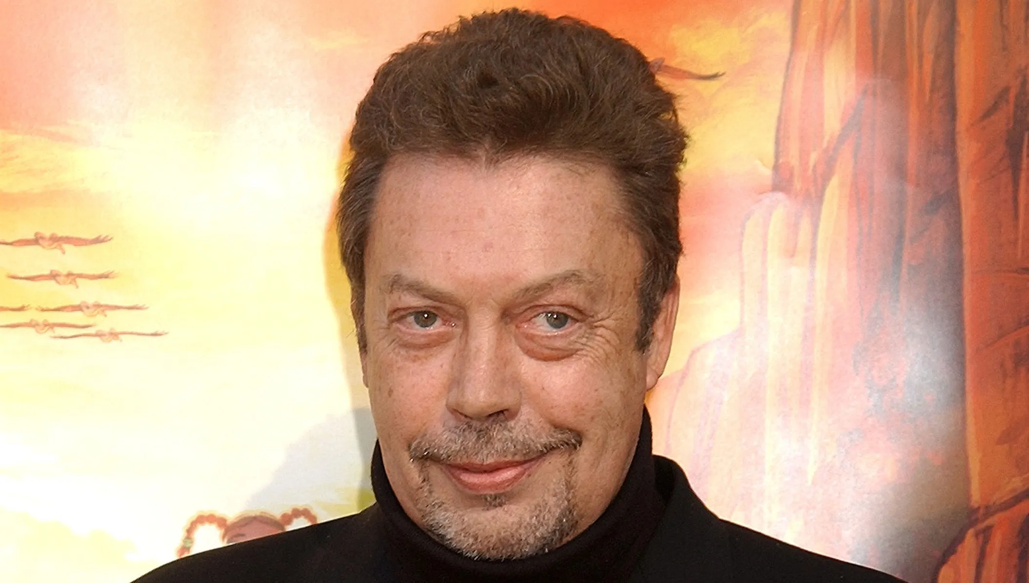 Tim Curry arriving at a Hollywood event