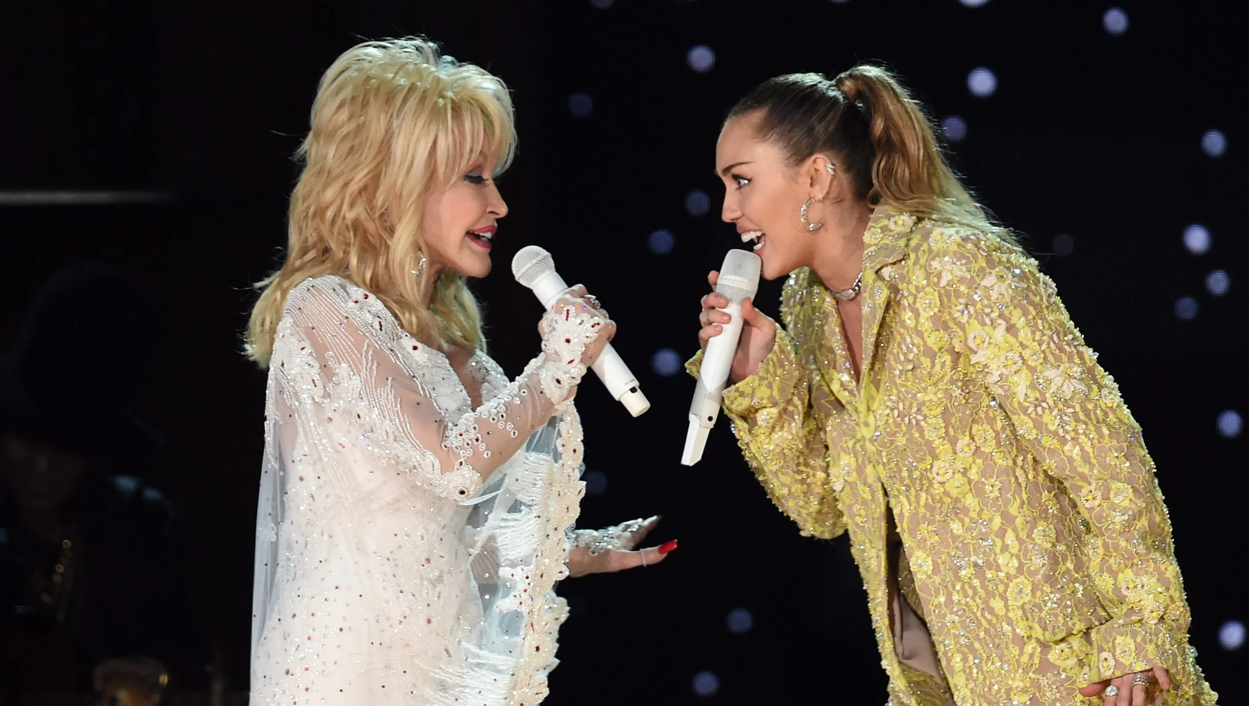 Miley Cyrus and Dolly Parton performing together on stage