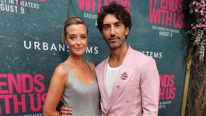Justin Baldoni and wife Emily Baldoni posing together on a carpet