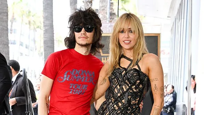 Miley Cyrus and Maxx Morando on a red carpet