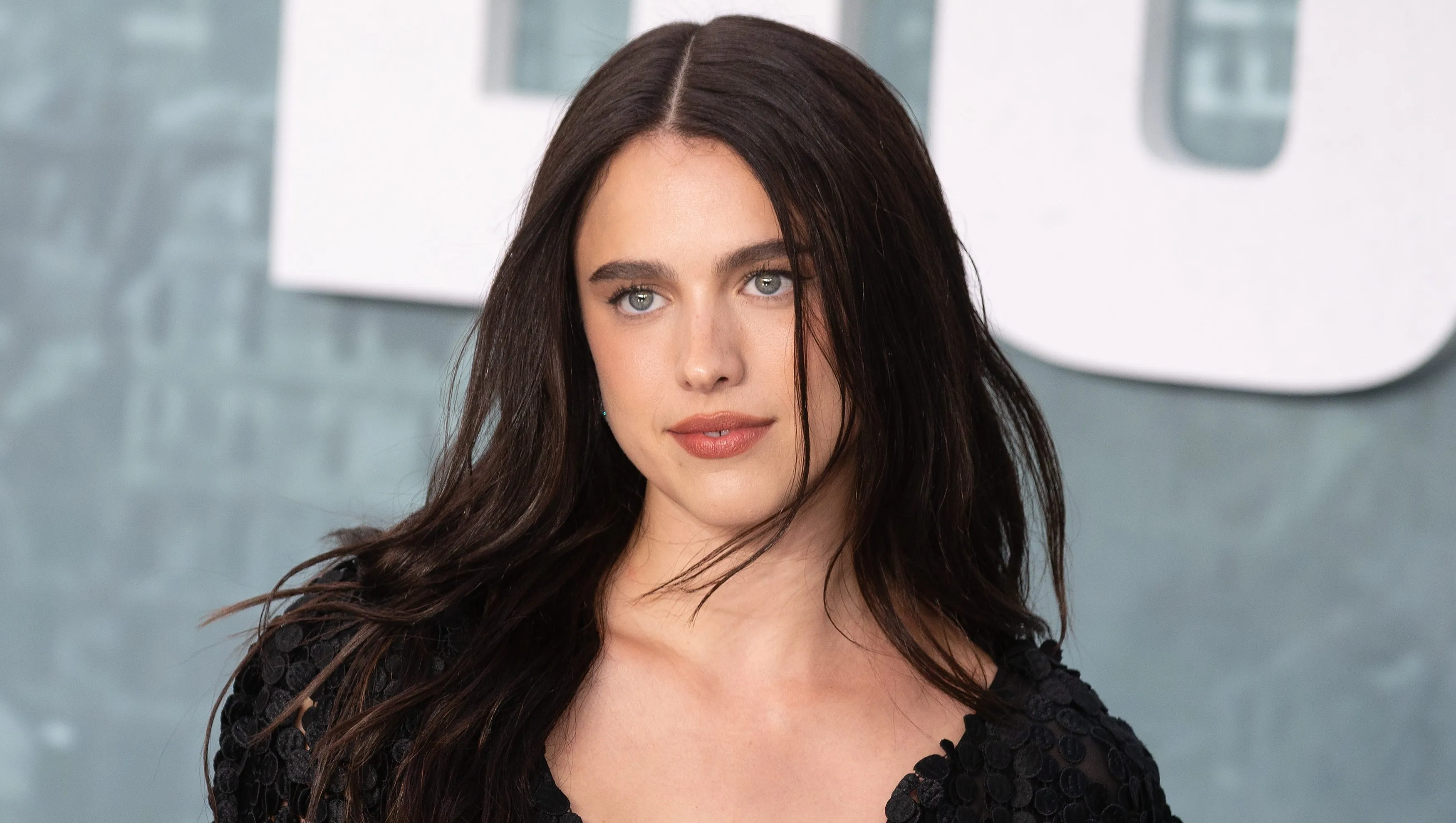 Margaret Qualley posing at a red carpet event for The Substance