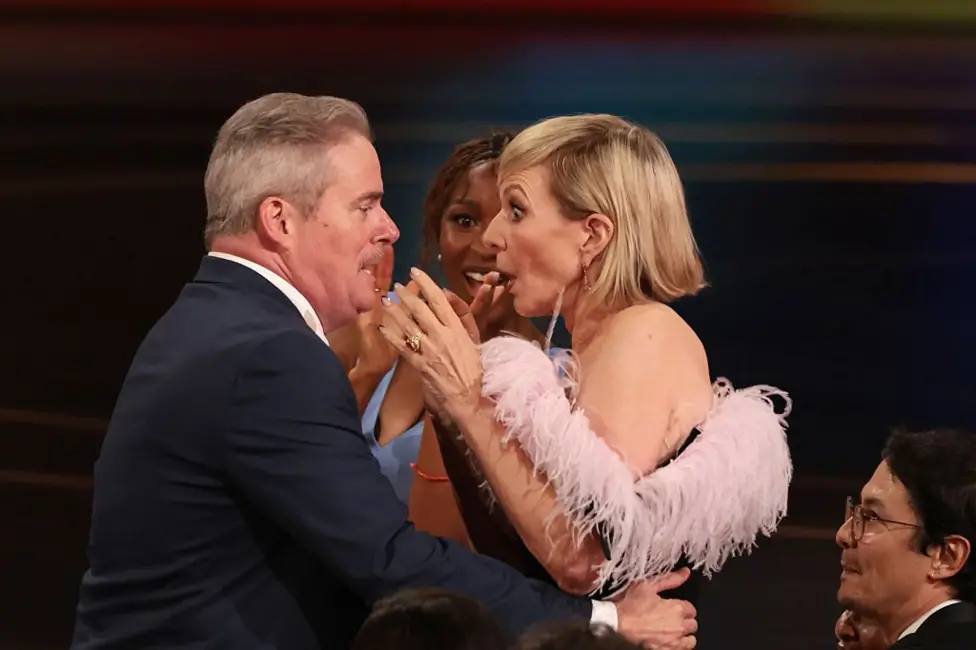 Emmy winner Allison Janney, right, is shocked and is embraced during the ceremony before her acceptance speech