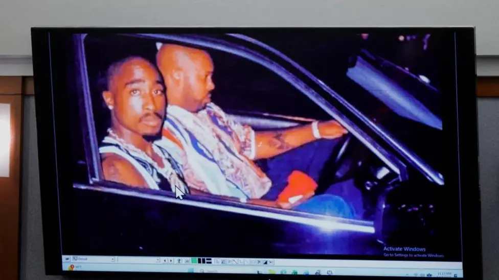 A 1996 photo of rapper Tupac Shakur (L) and Marion "Suge" Knight is displayed during the Duane Davis murder trial.