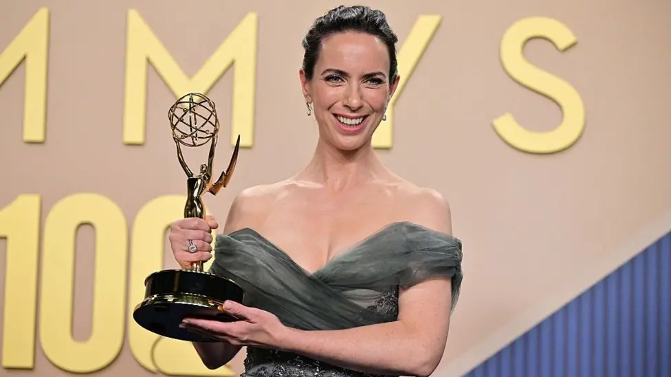 Kate O'Flynn holds up her Emmy Awards statue backstage after accepting the prize for supporting actor in a comedy series