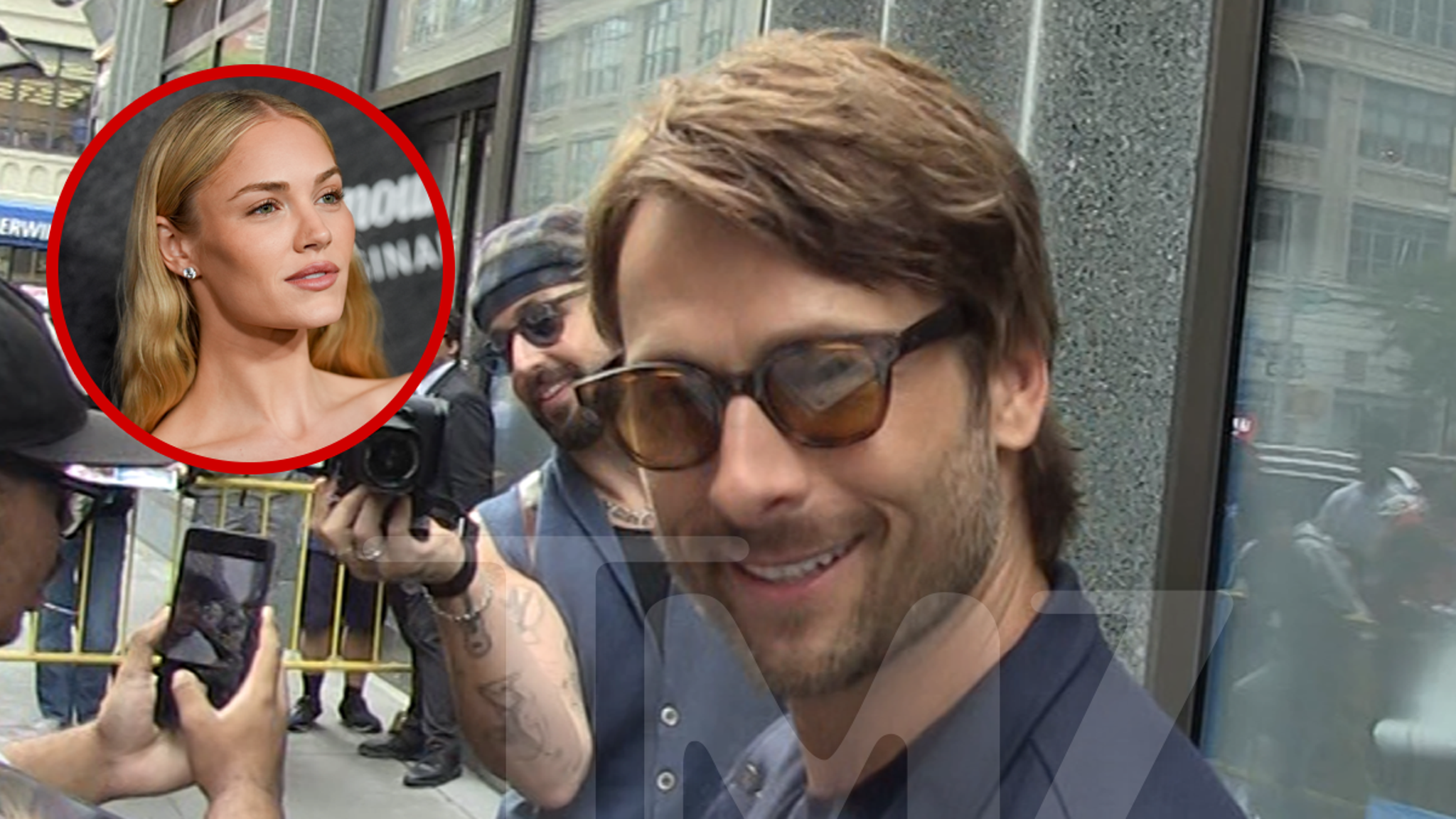 Glen Powell smiling while out in New York City