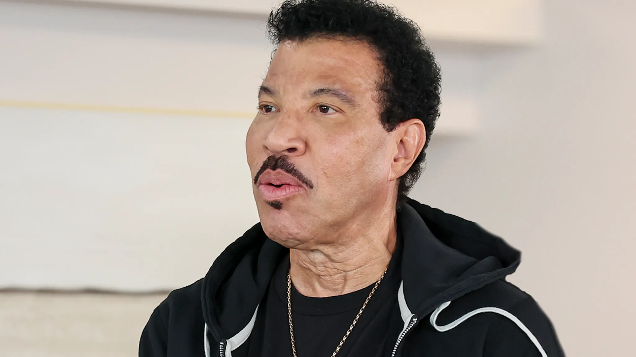 Lionel Richie performing on stage at a concert