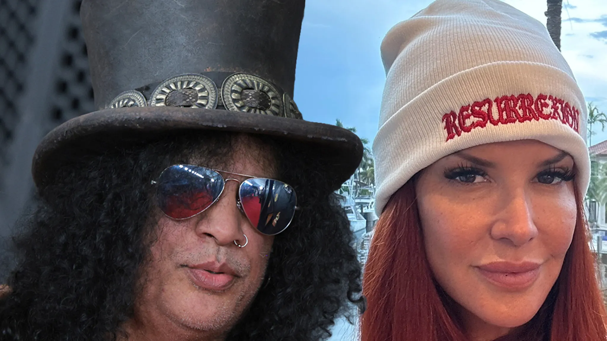 Guns N' Roses guitarist Slash performing live on stage in his iconic top hat