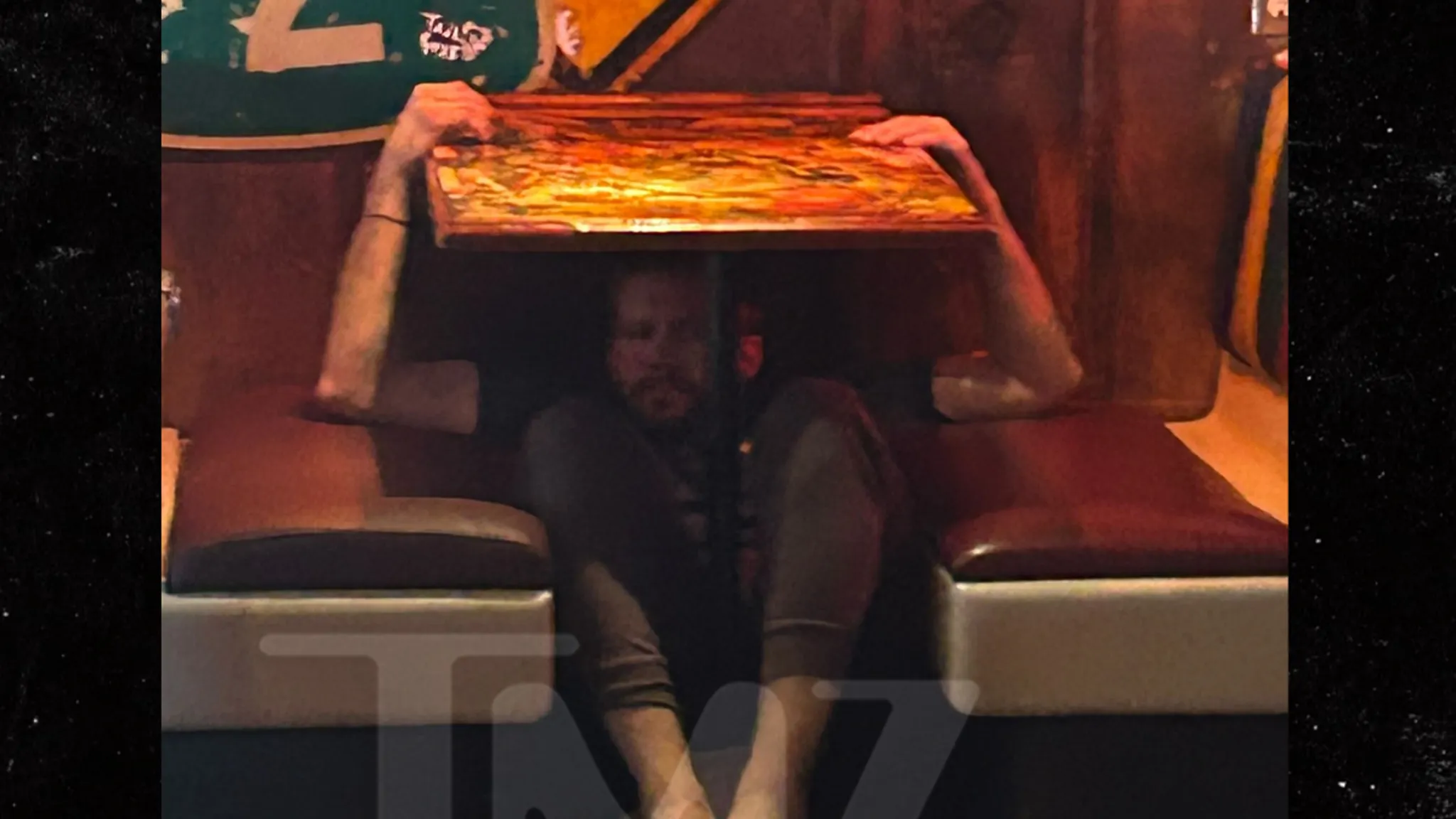 Brian Hickerson hiding under a restaurant table before his arrest