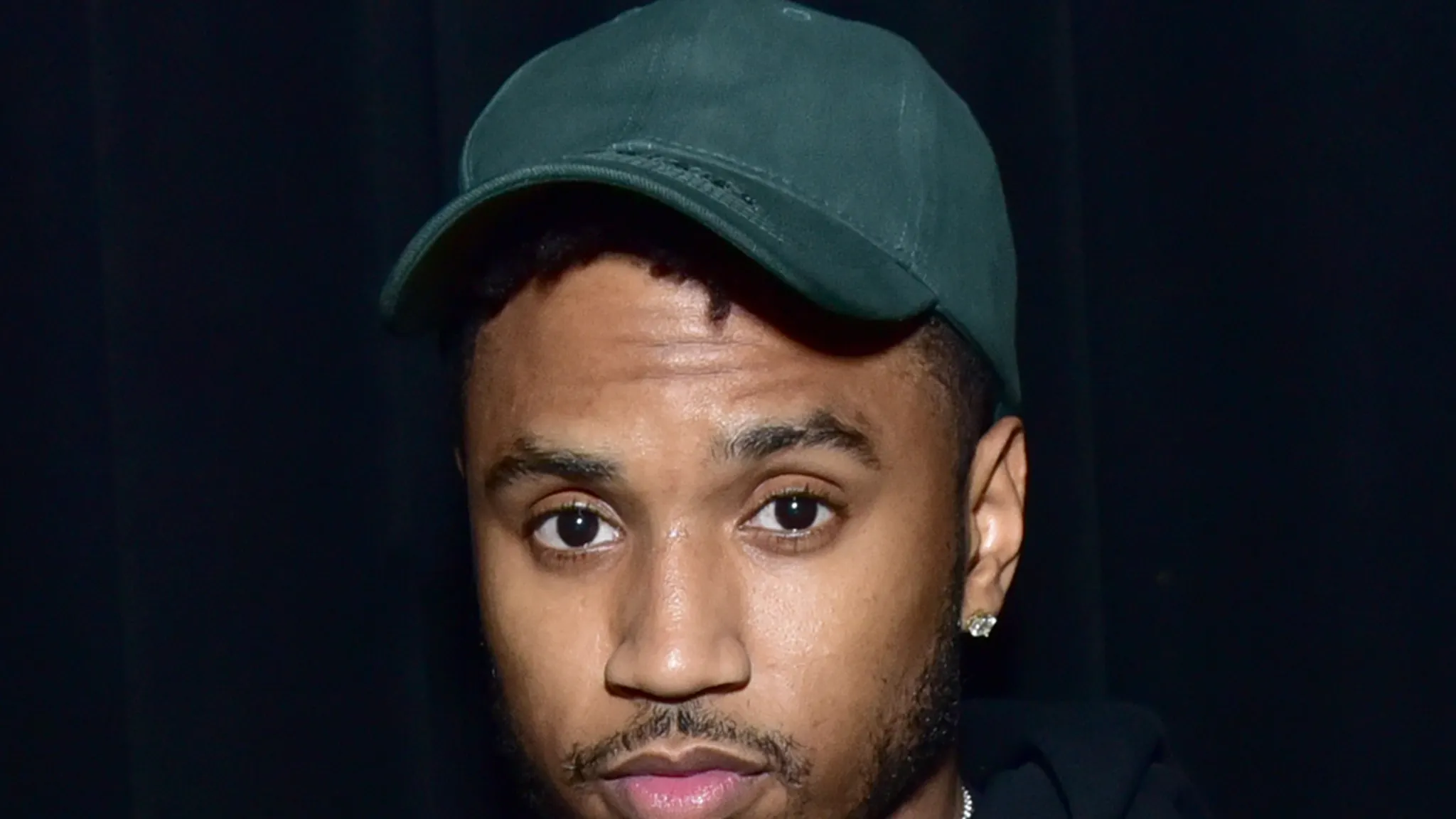 Trey Songz posing on a red carpet at a showbiz event