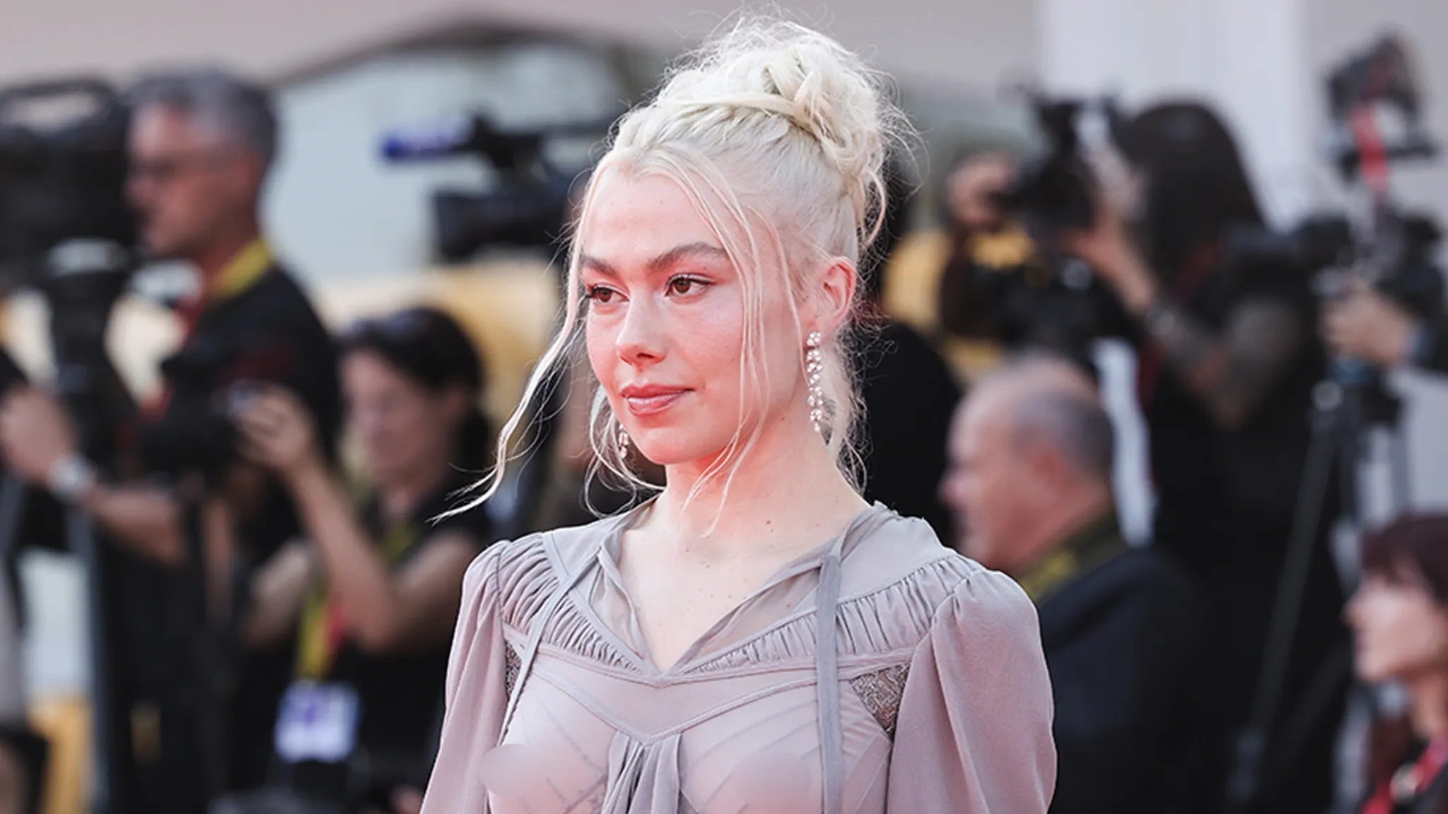 Phoebe Bridgers wearing a sheer dress on the Venice Film Festival red carpet