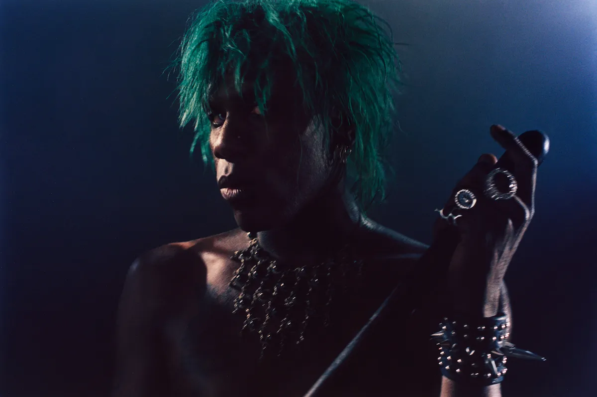 Yves Tumor performing live on stage under concert lights