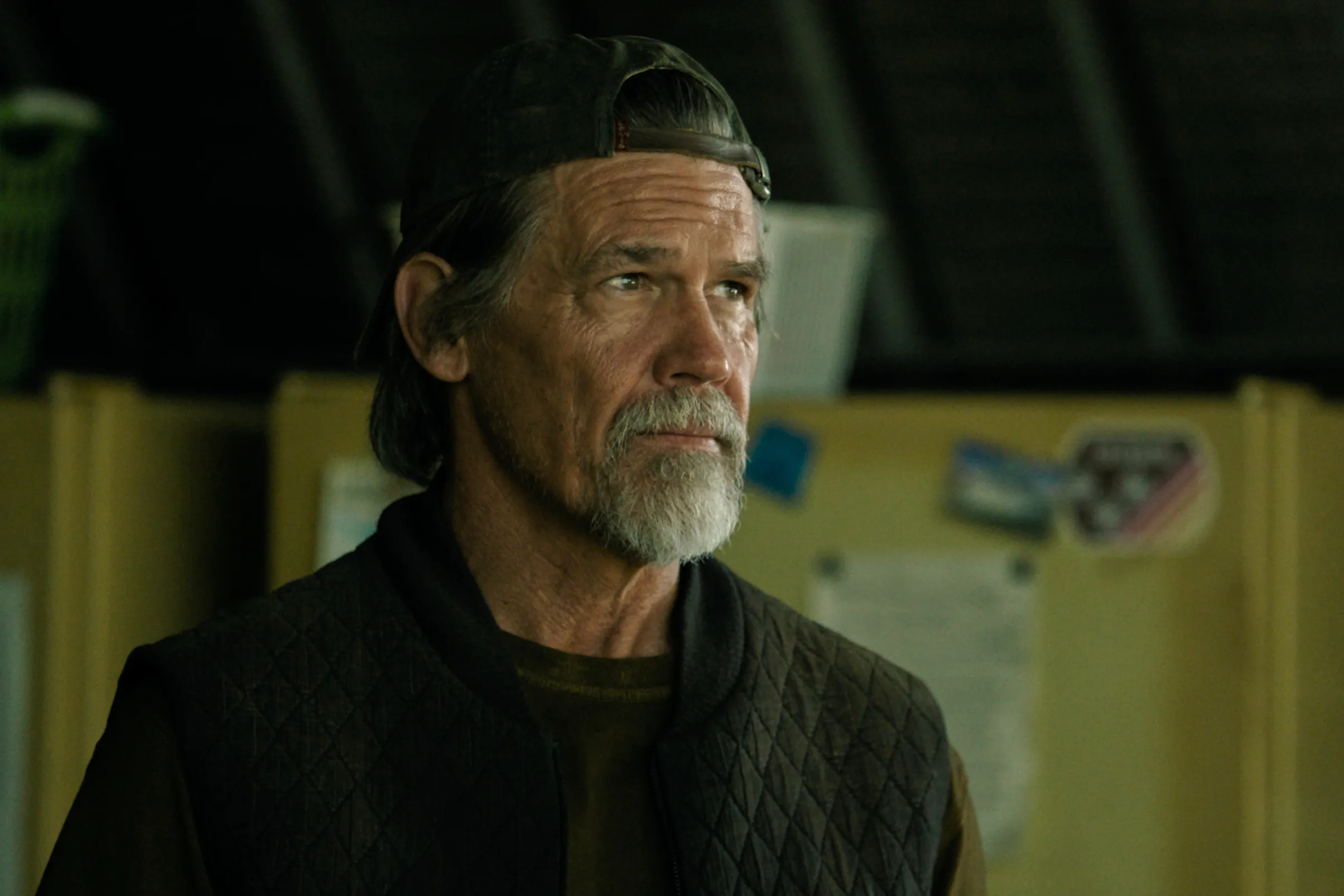 Josh Brolin with a beard and wearing a baseball cap and quilted vest in a scene from "The Dog Stars."