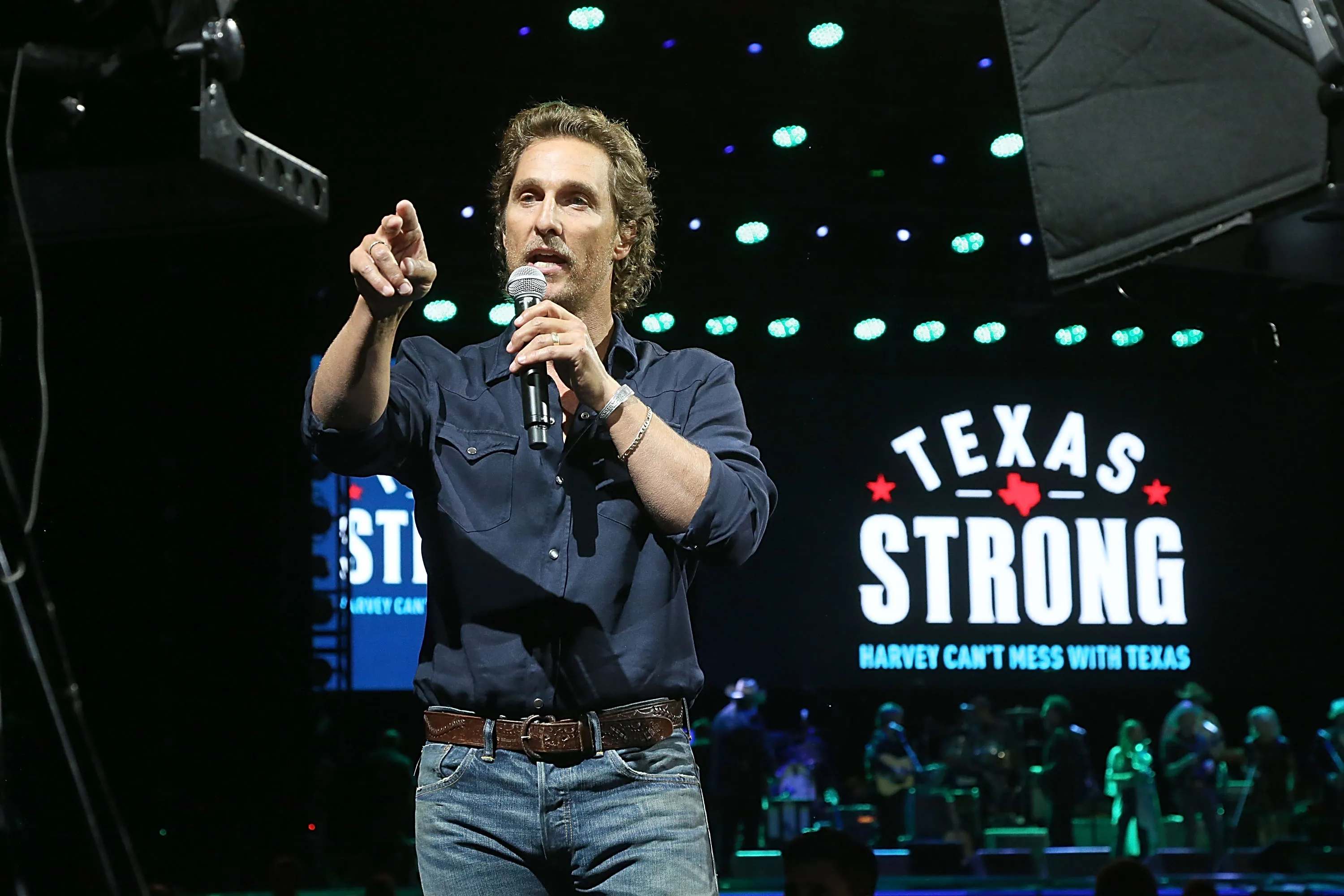 Matthew McConaughey speaks into a microphone at the "Texas Strong: Hurricane Harvey Can