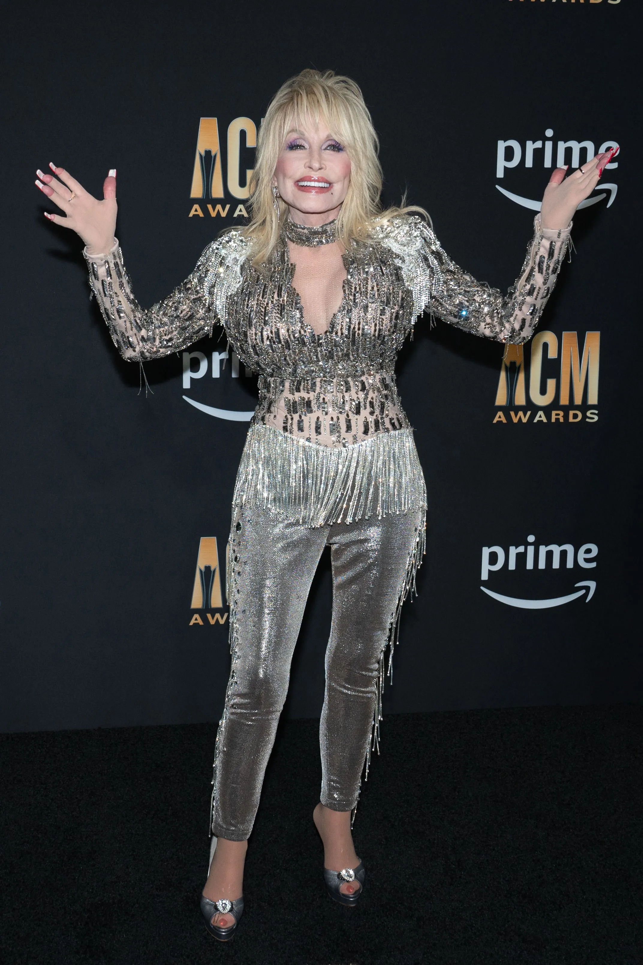 Dolly Parton in a sparkly silver jumpsuit at the Academy of Country Music Awards.