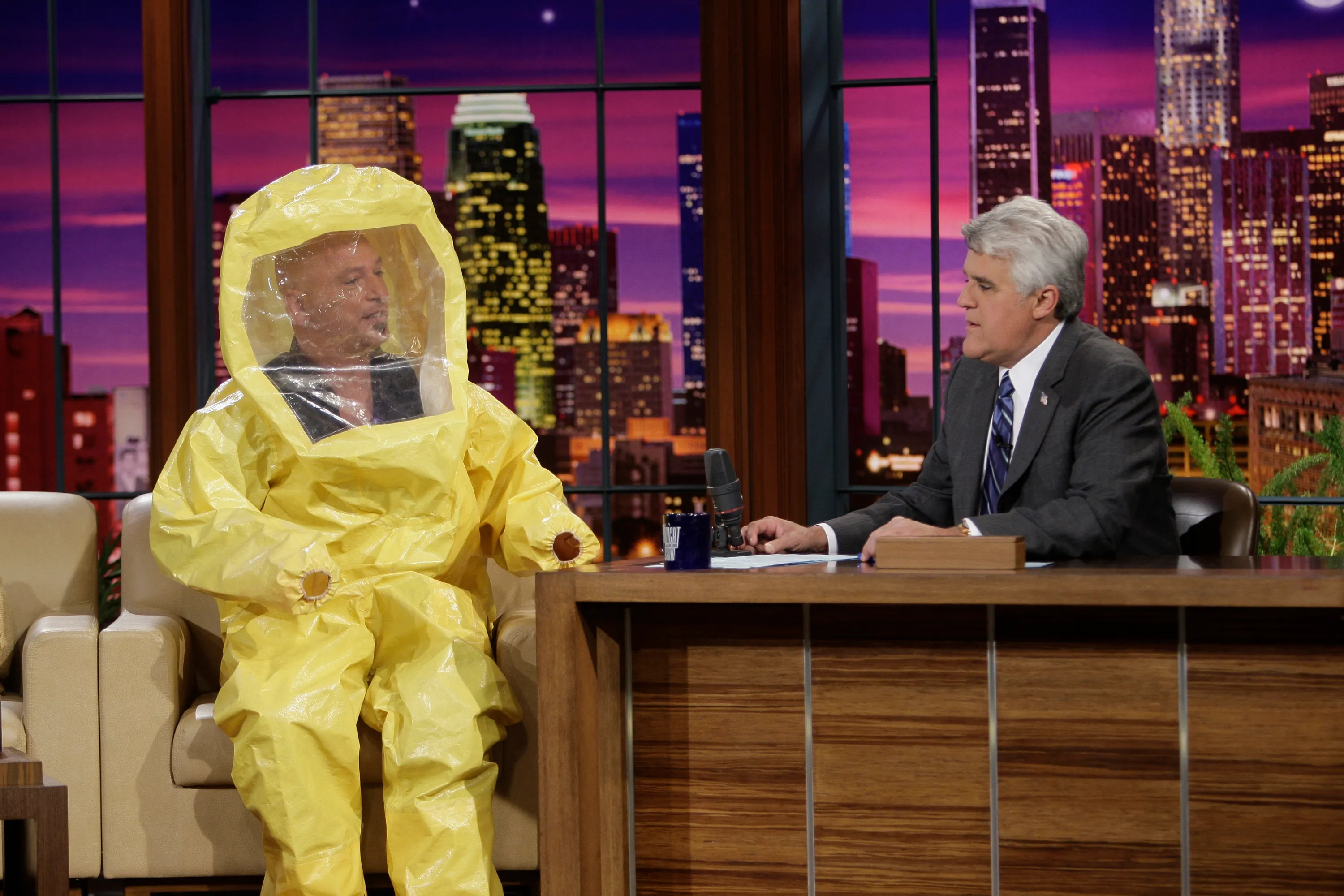Howie Mandel wearing a hazmat suit during an interview with Jay Leno on The Tonight Show.