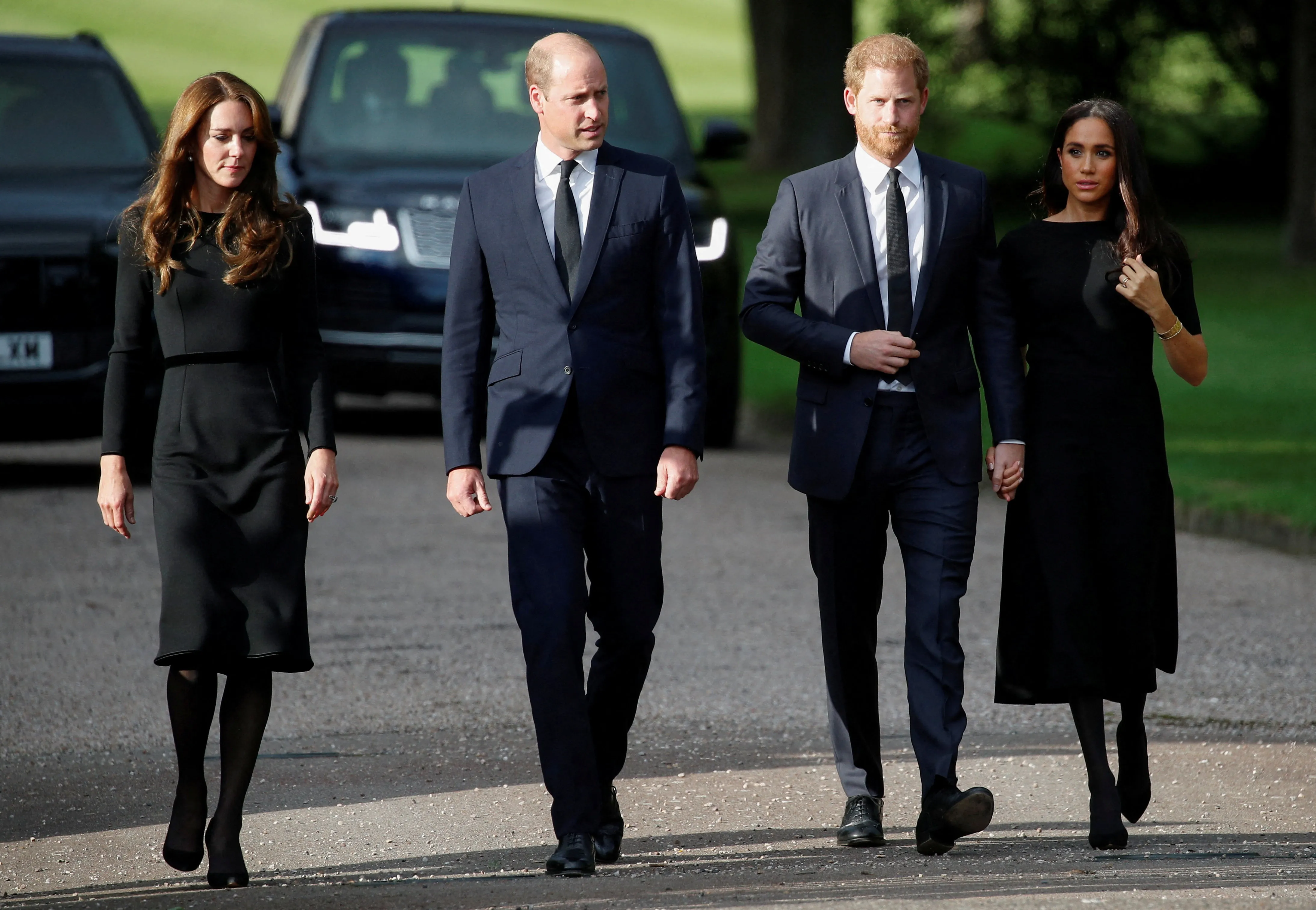 Prince William, Princess Catherine, Prince Harry, and Meghan, the Duchess of Sussex, walk together outside Windsor Castle.