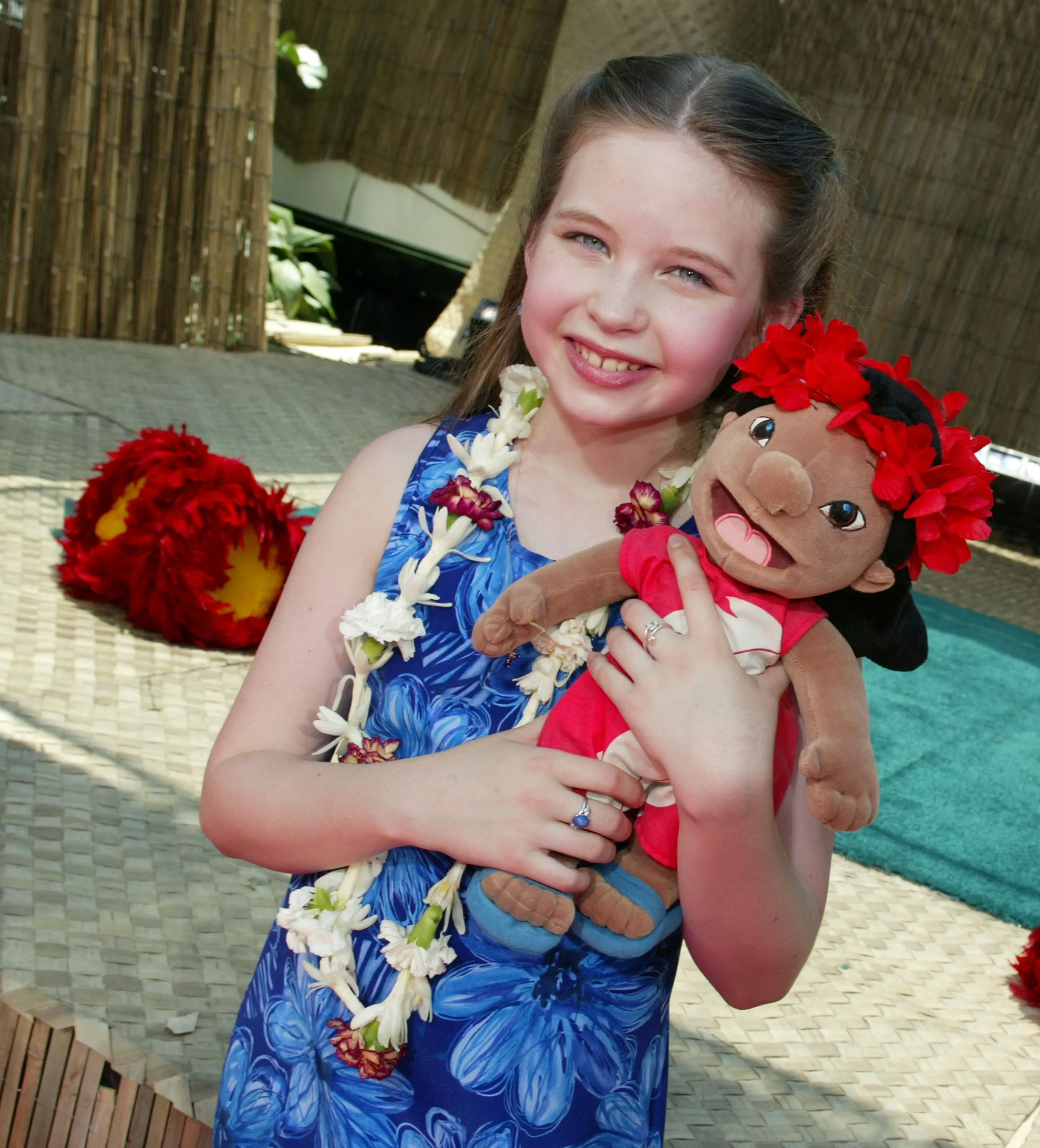 Daveigh Chase, voice of Lilo, holding a Lilo plush doll at the "Lilo & Stitch" premiere.