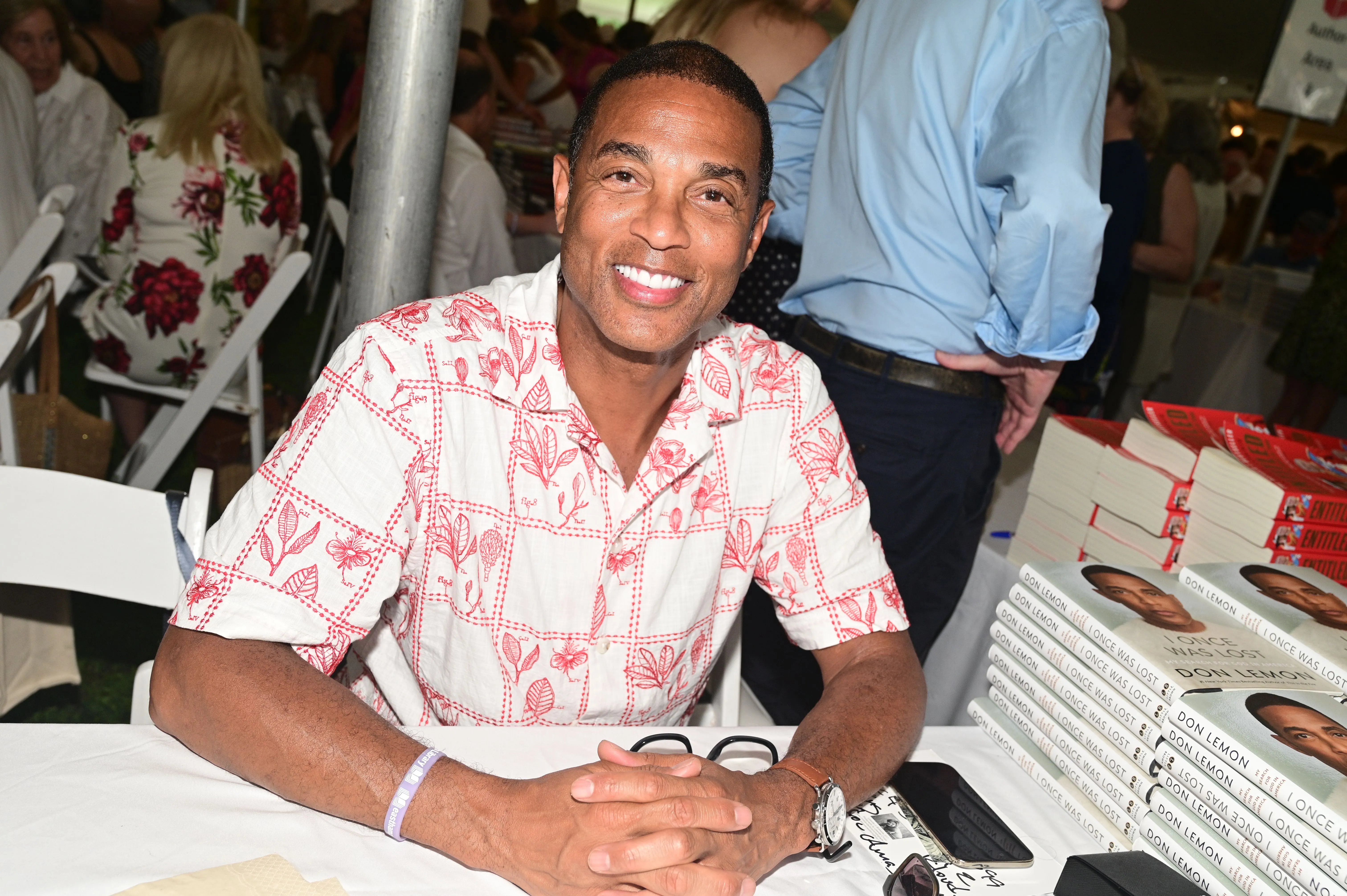 Don Lemon smiling at a book signing event.