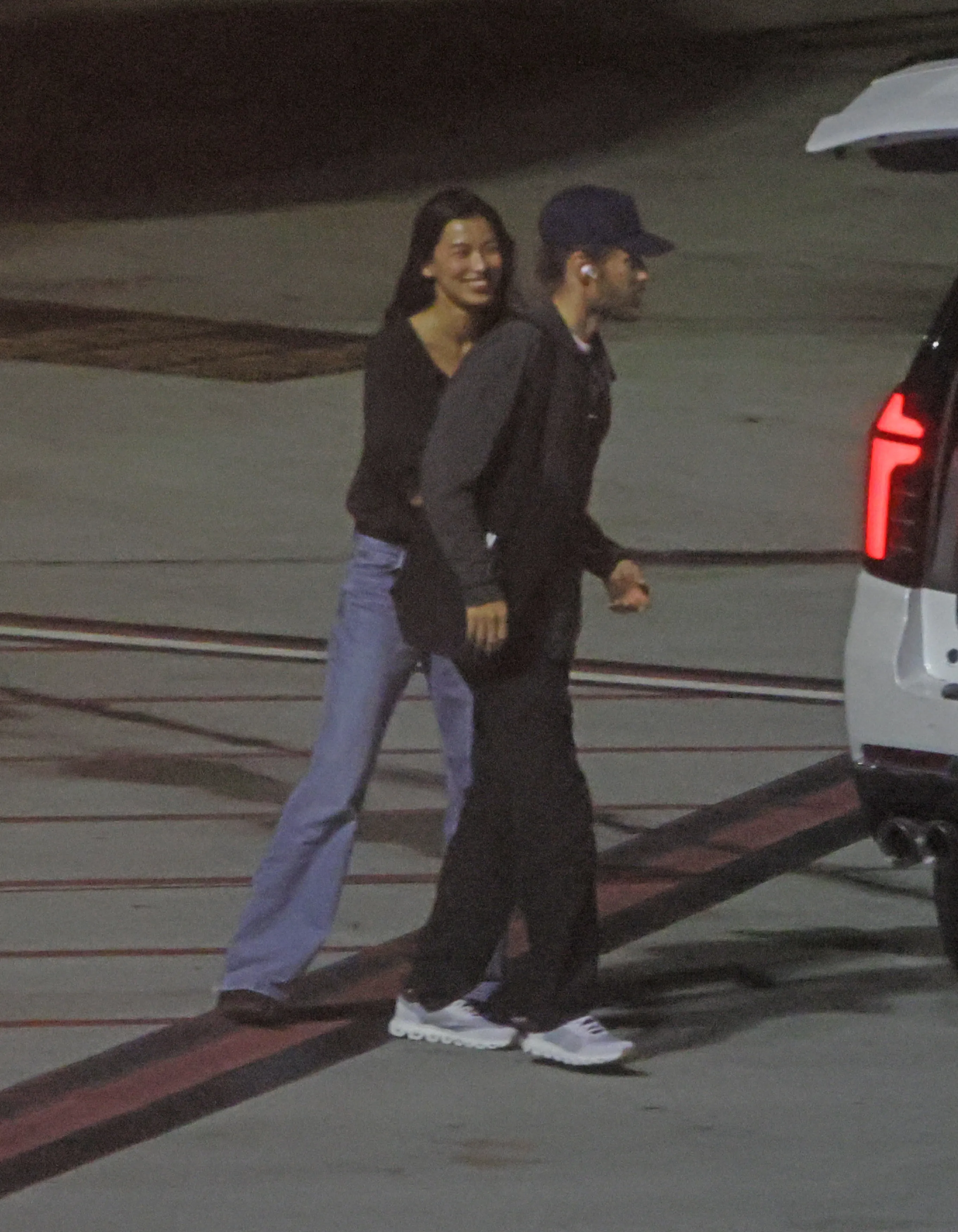 Jared Leto and Thet Thinn sharing a kiss on the tarmac at LAX.