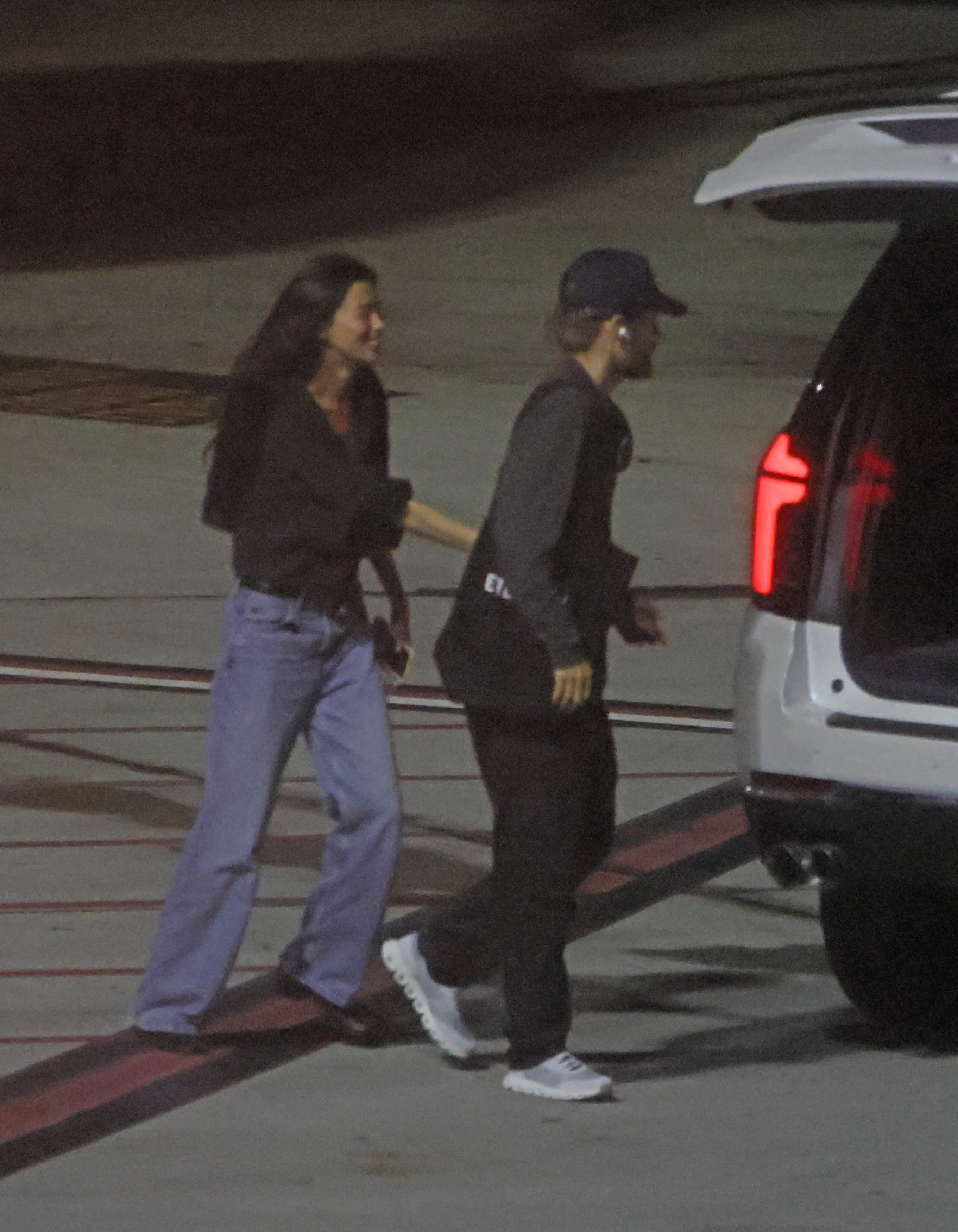 Jared Leto and Thet Thinn walking together at LAX.
