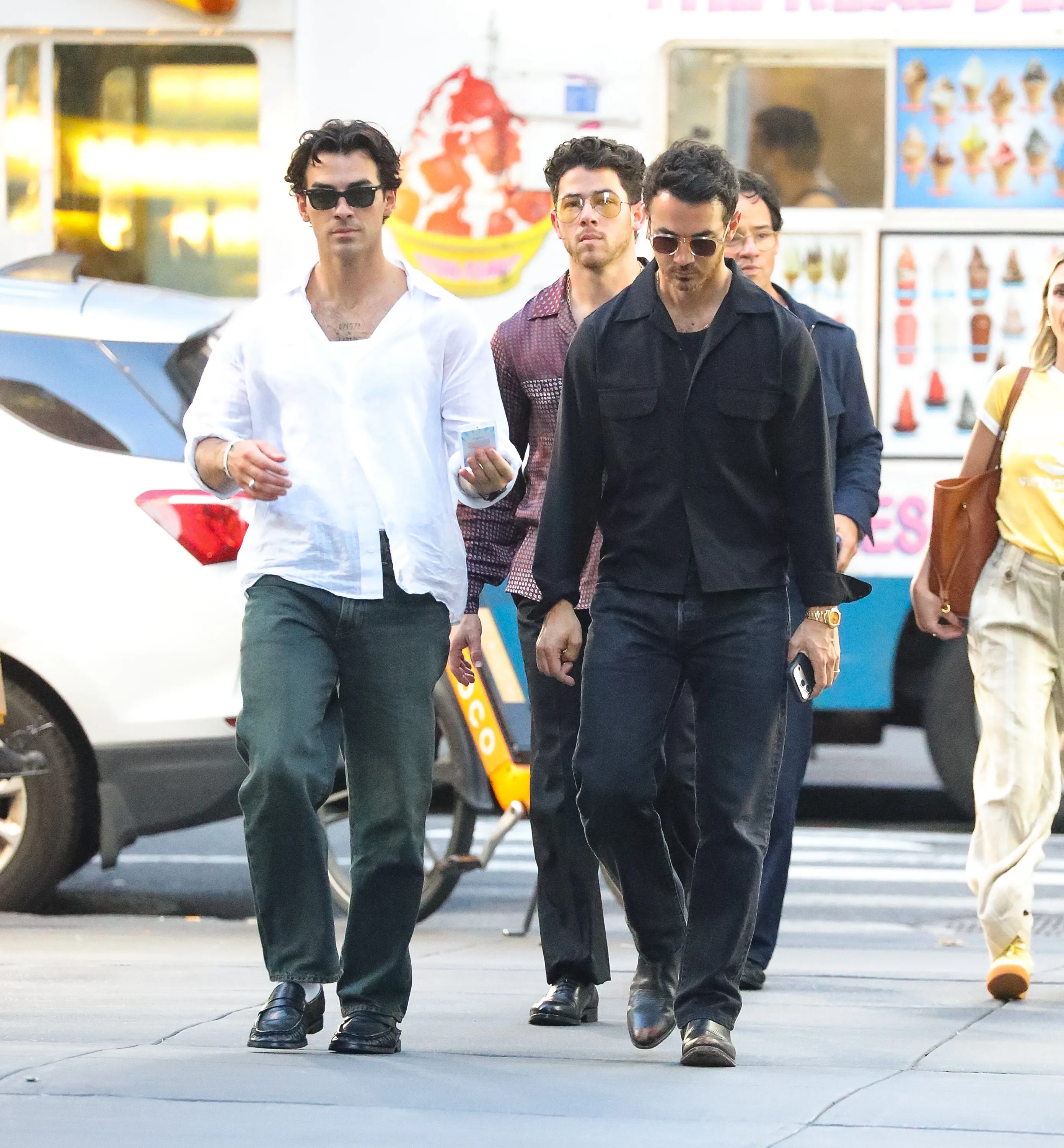 The Jonas Brothers walking in New York City after an iHeartRadio event.
