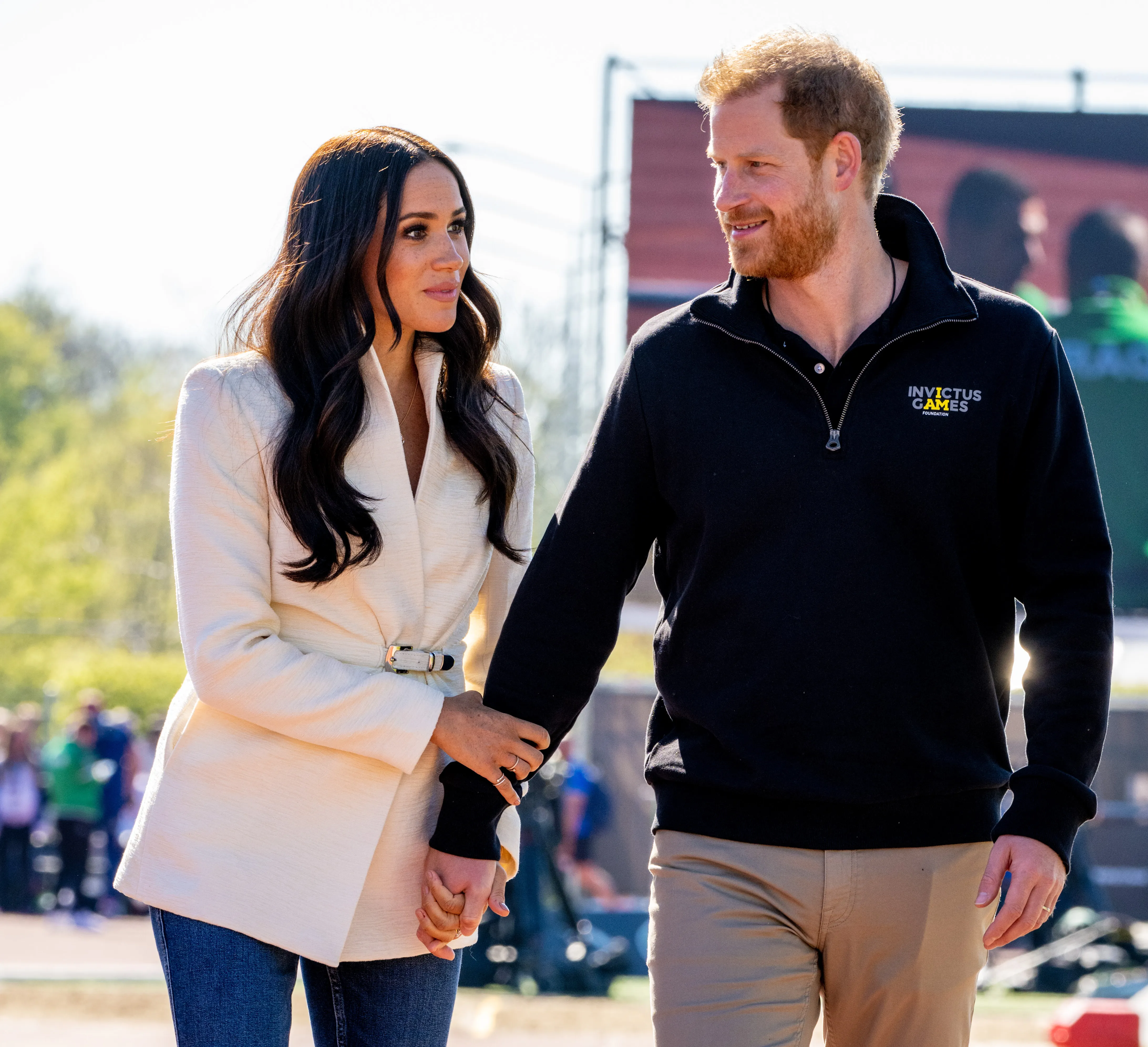 Meghan Markle and Prince Harry holding hands.