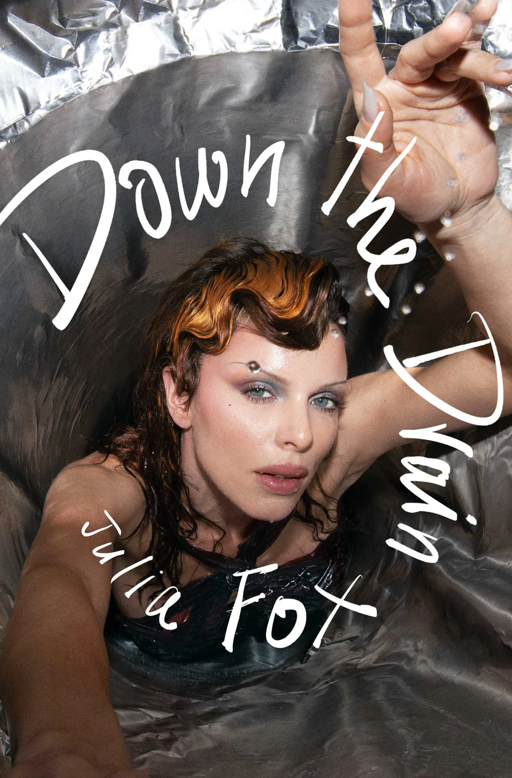 Julia Fox submerged in water with the words "Down The Drain Julia Fox" overlaying the image.