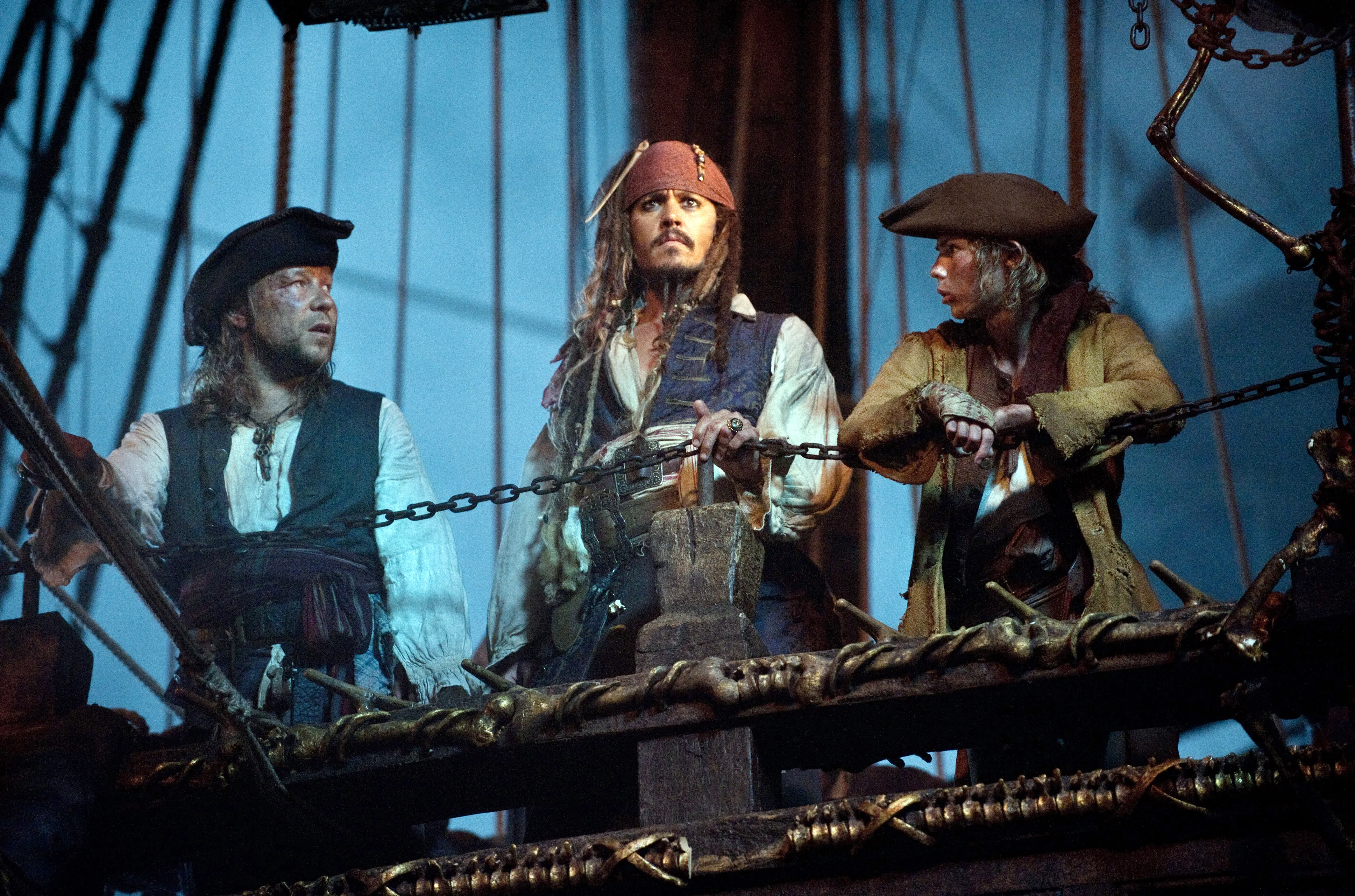 Johnny Depp as Captain Jack Sparrow, Robbie Kay as Cabin Boy, and another pirate in "Pirates of the Caribbean: On Stranger Tides."