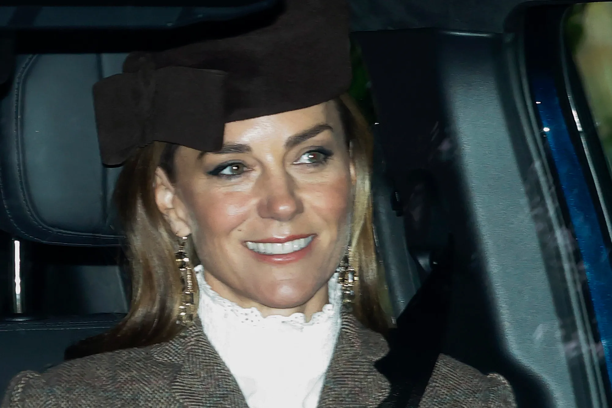 Kate Middleton smiling with her newly lightened honey-blonde hair while at the Balmoral estate.