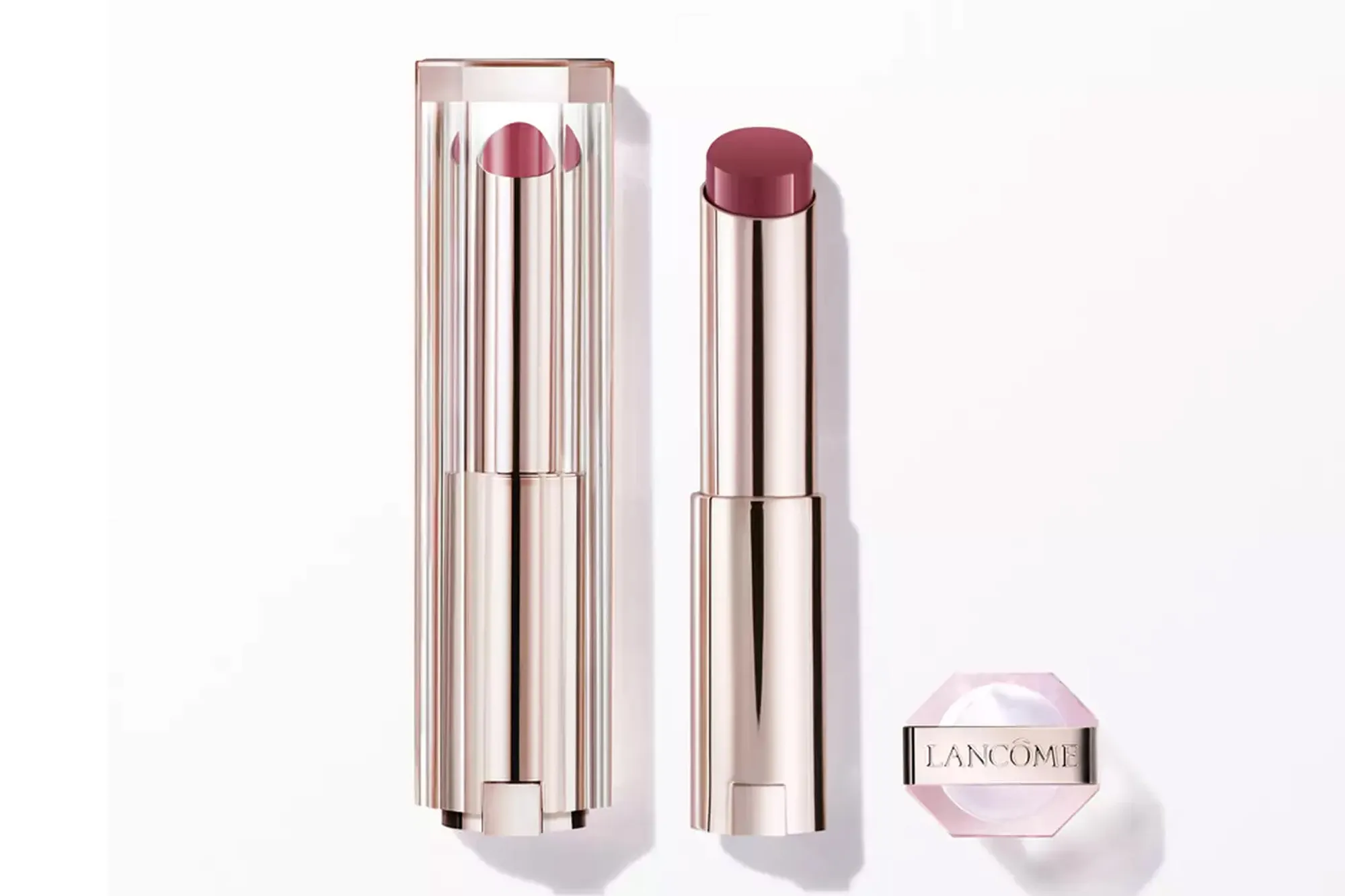 Lancôme lipstick in an open and closed rose gold tube with a small jar of Lancôme cream.