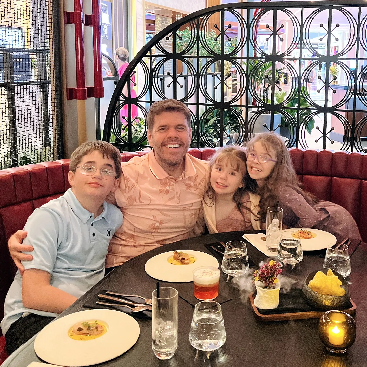 with his three children in a restaurant.