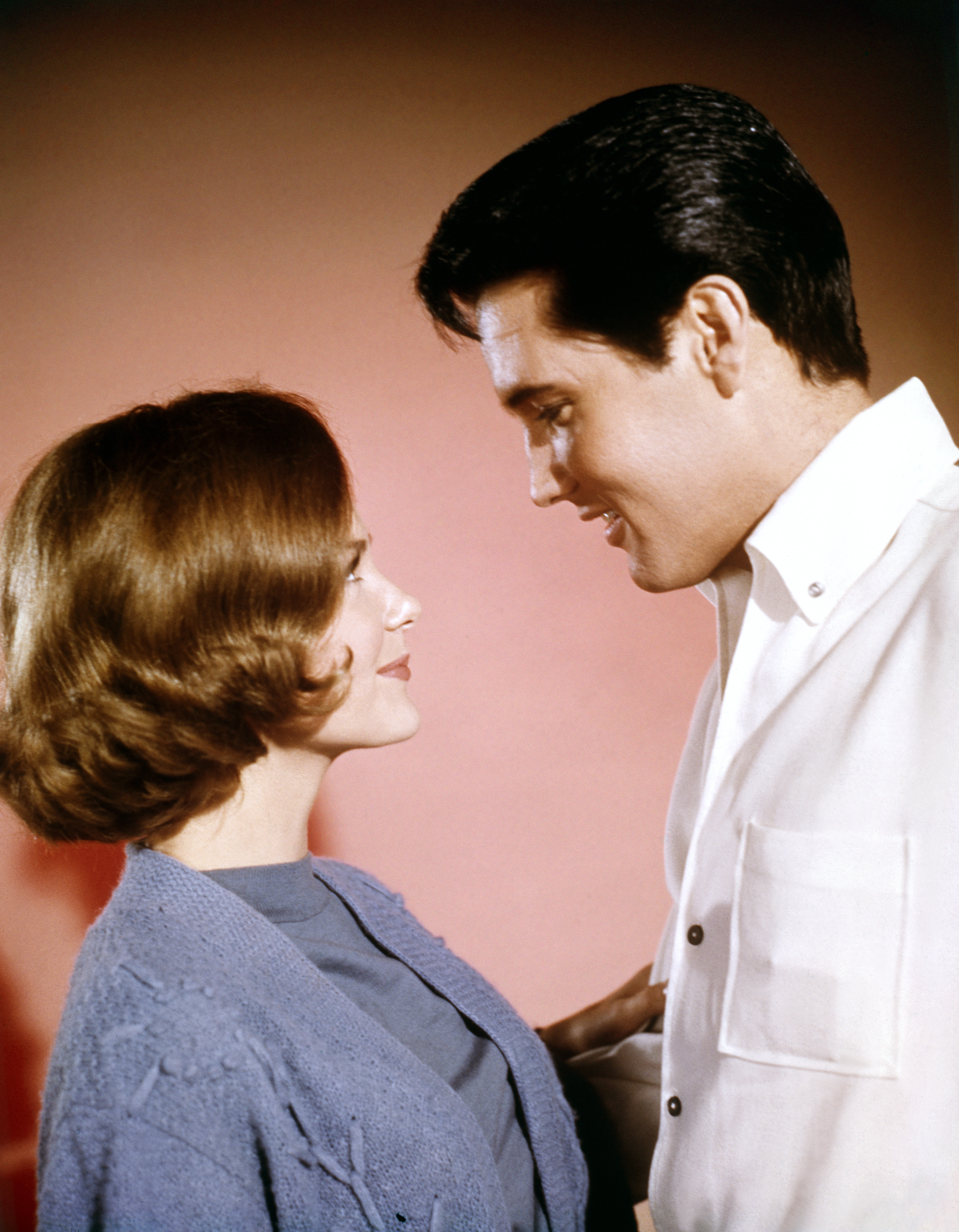 Portrait of Shelley Fabares and Elvis Presley looking at each other.