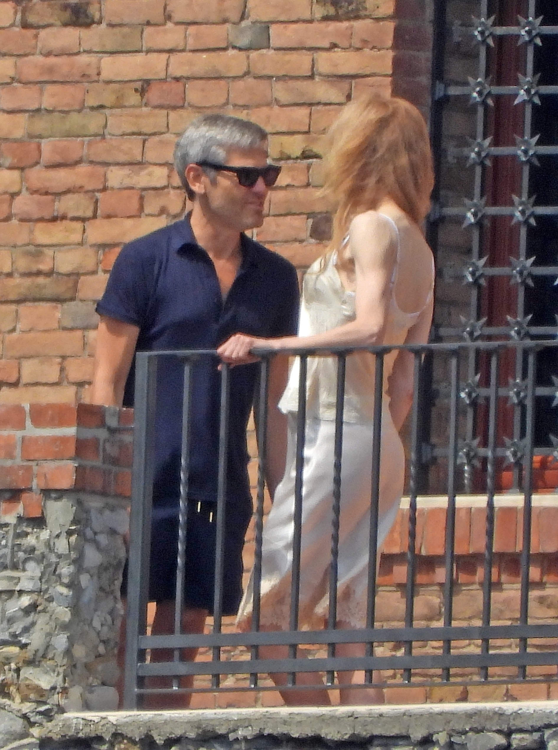 Nicole Kidman on a balcony in Portofino sharing a farewell with a mystery man.