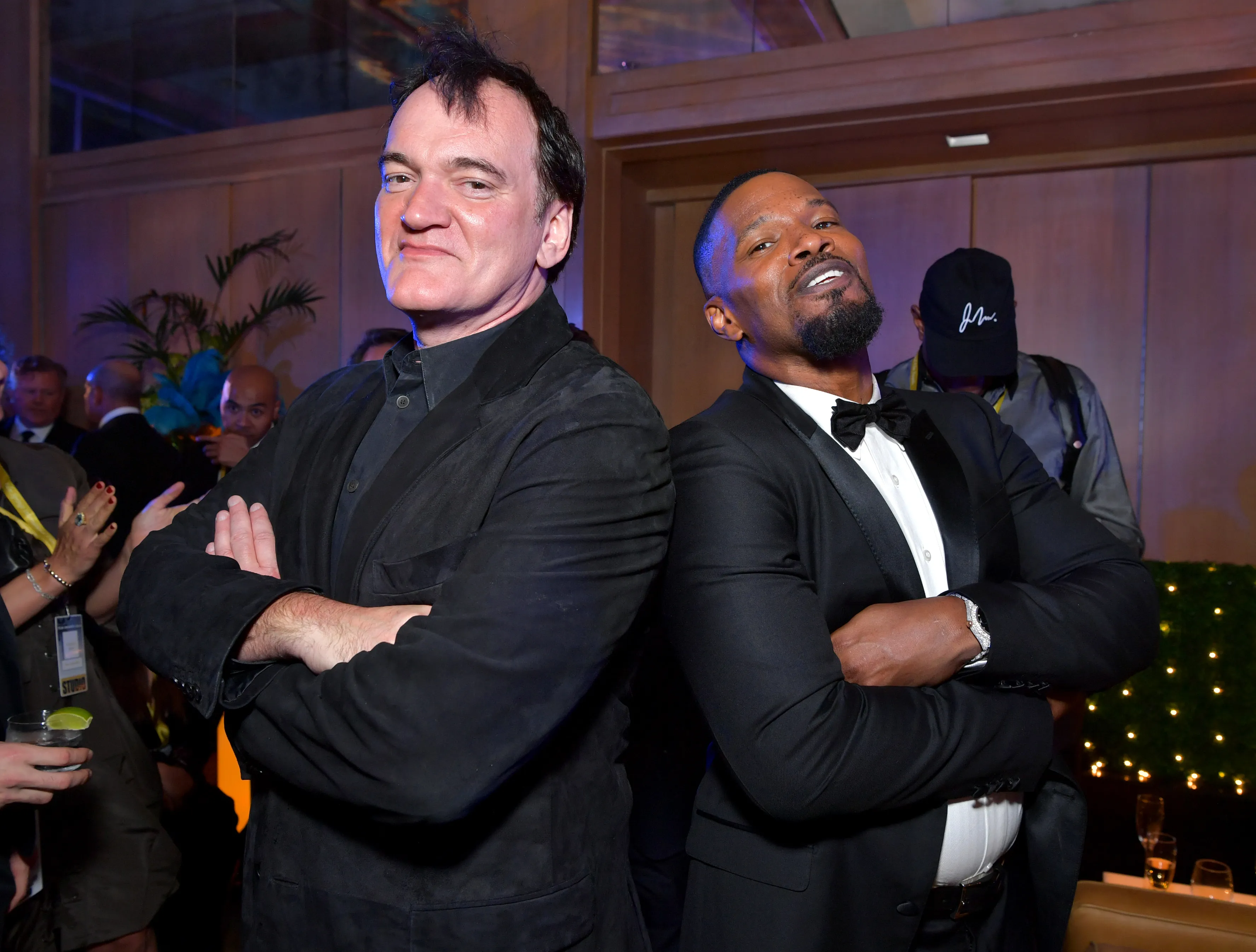 Quentin Tarantino and Jamie Foxx posing with their arms crossed at an after-party.