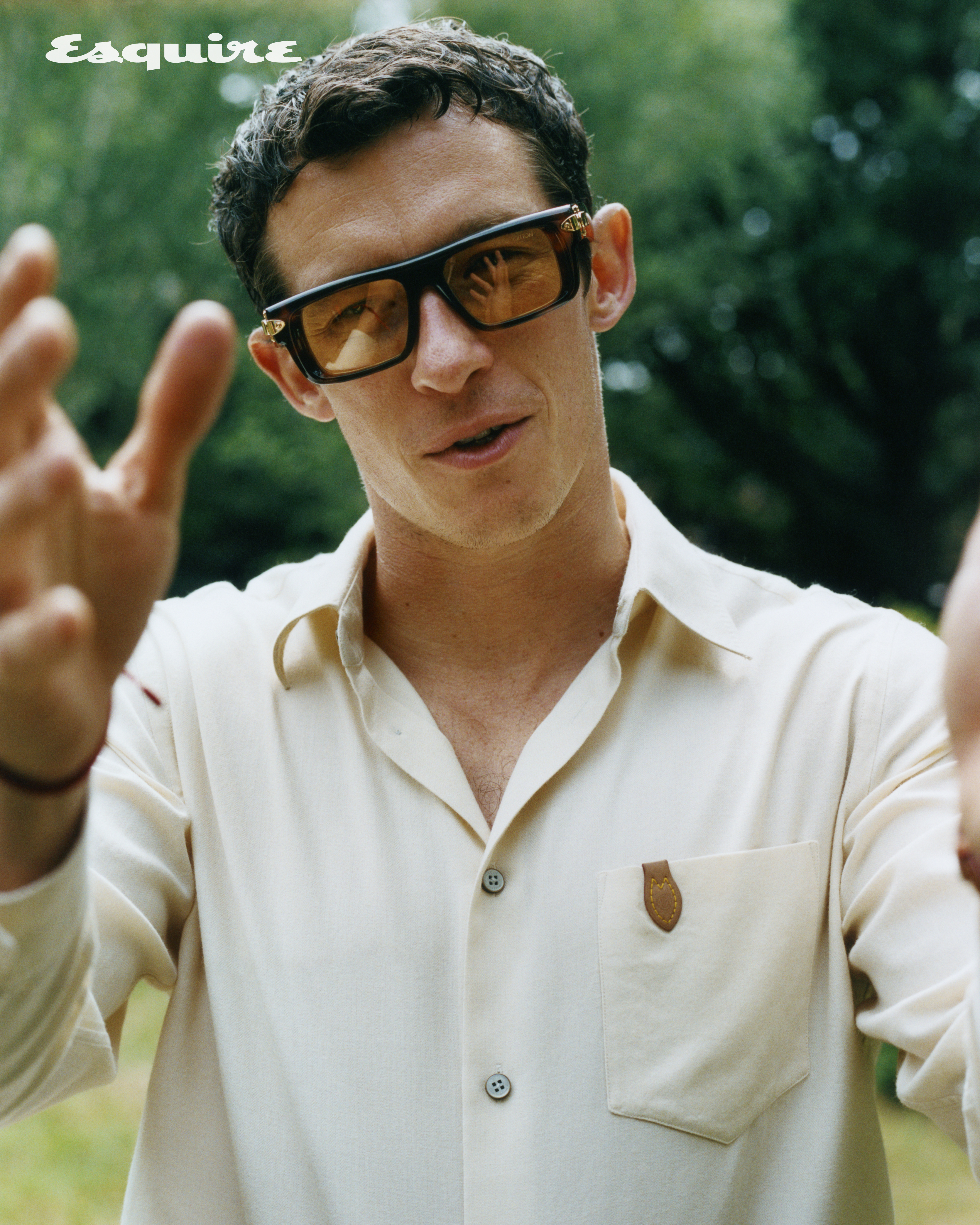 Callum Turner in sunglasses with a person