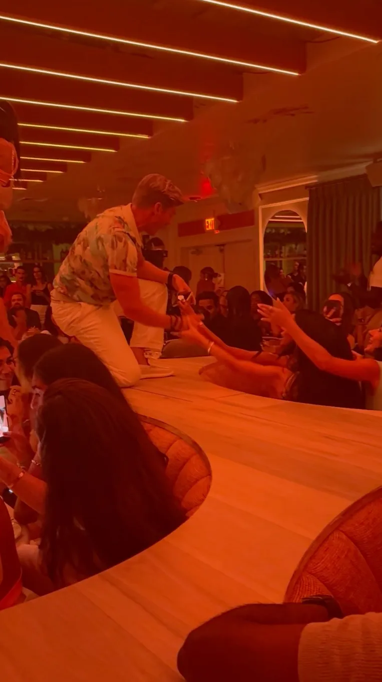 Kyle Cooke was the first to jump on the banquette following a performance by burlesque dancers.