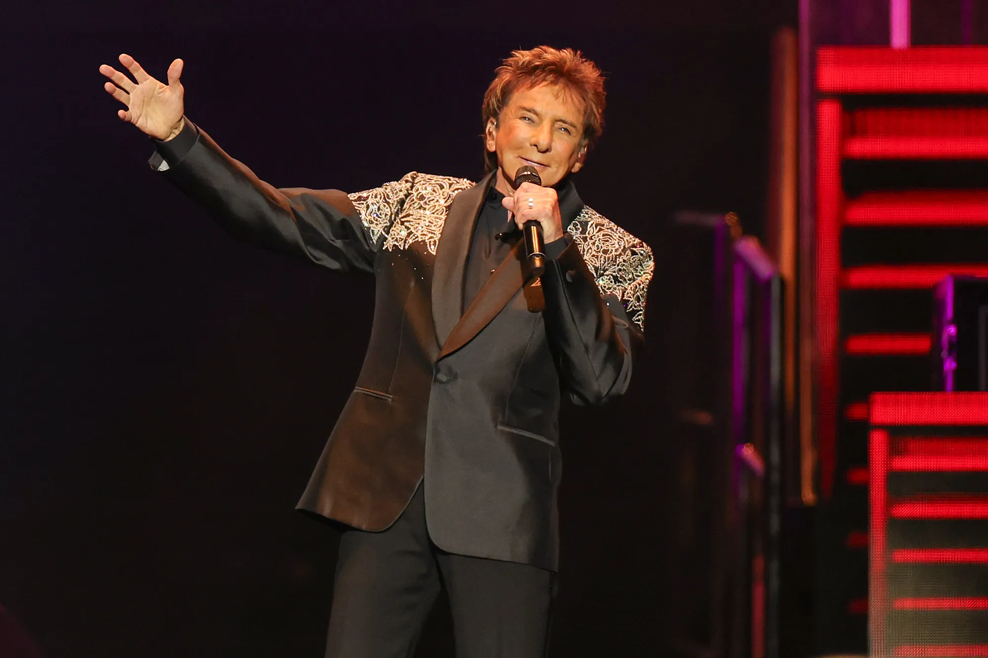 An image of Barry Manilow performing on stage