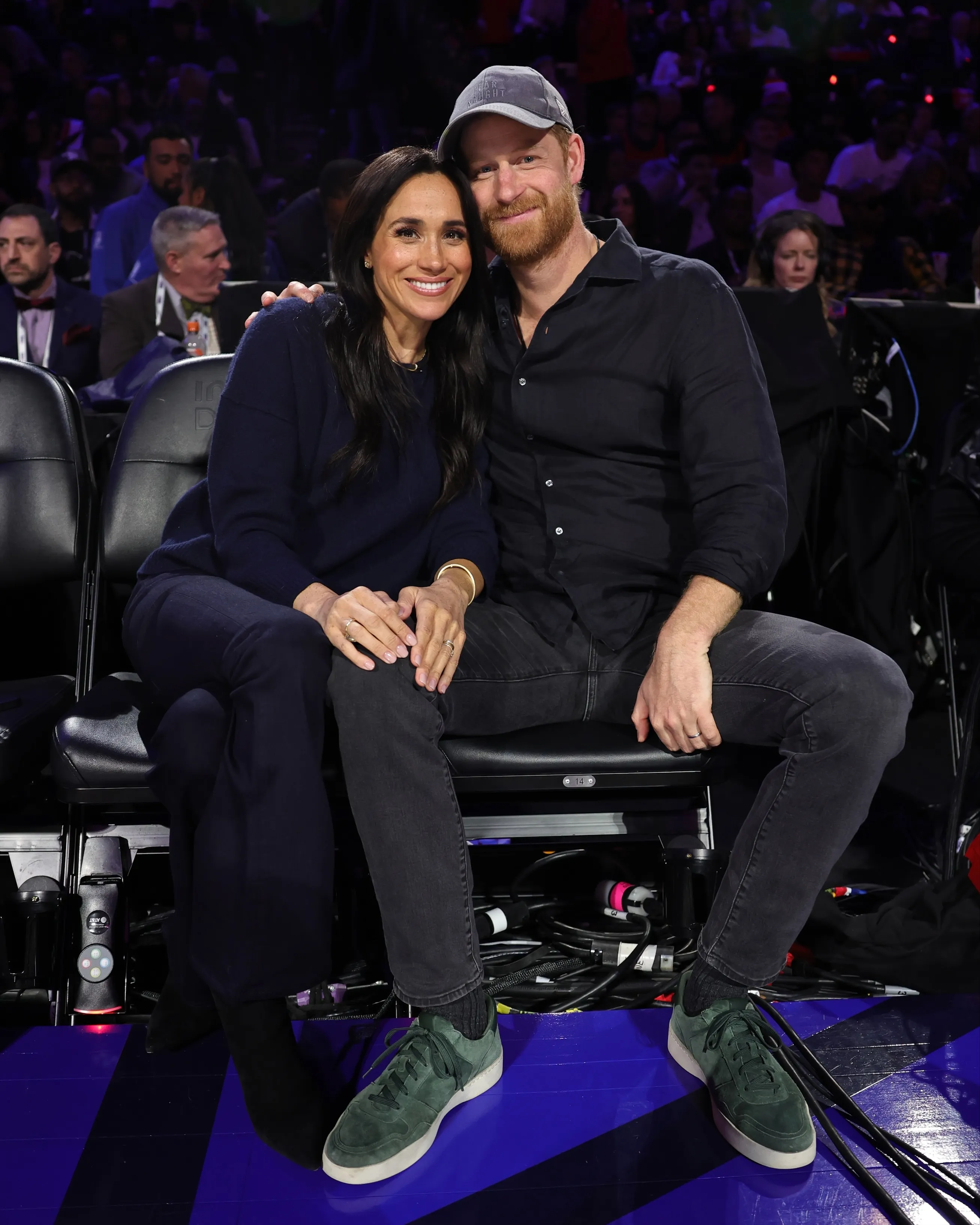 Meghan Markle and Prince Harry posing for a picture during the 75th NBA All-Star Game.