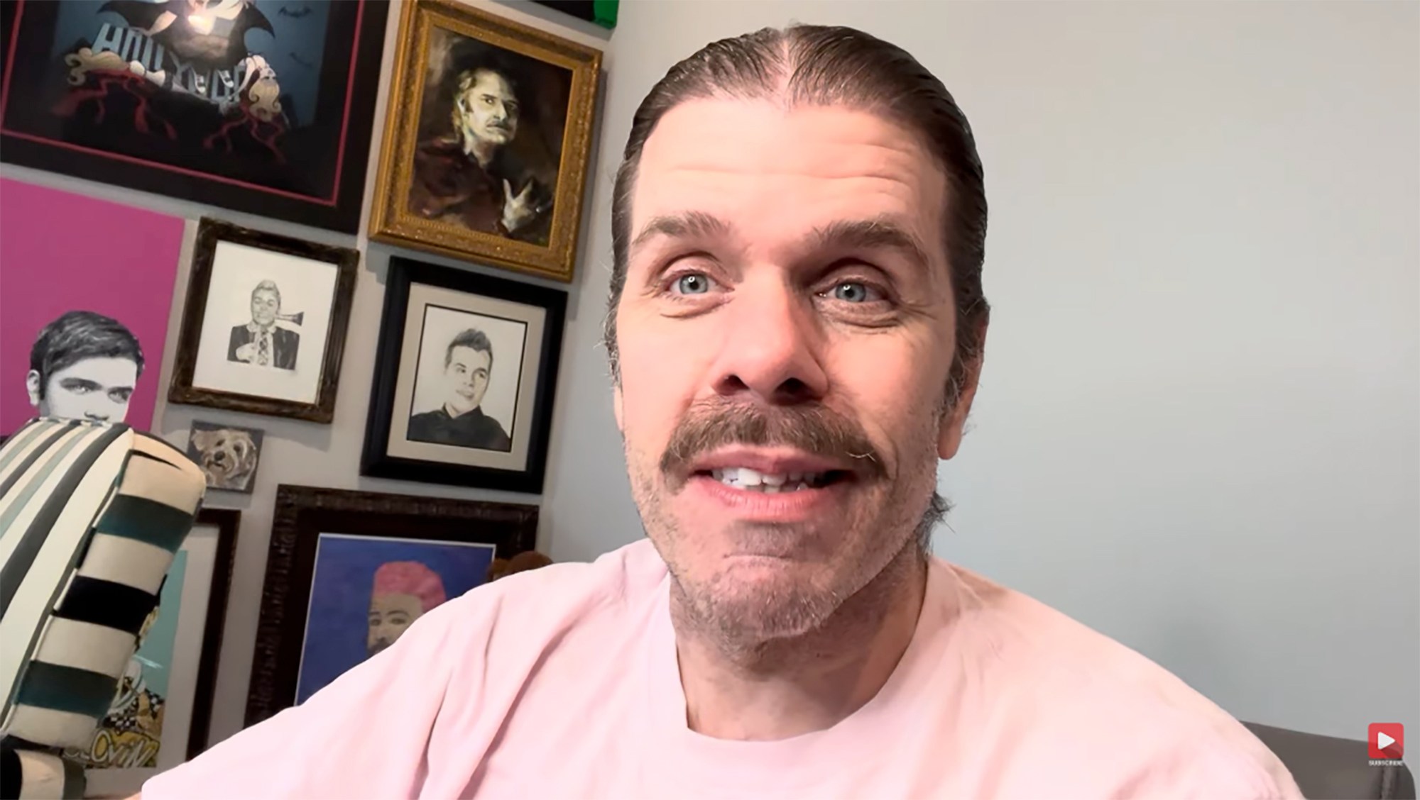 in a video close-up, surrounded by various artworks.
