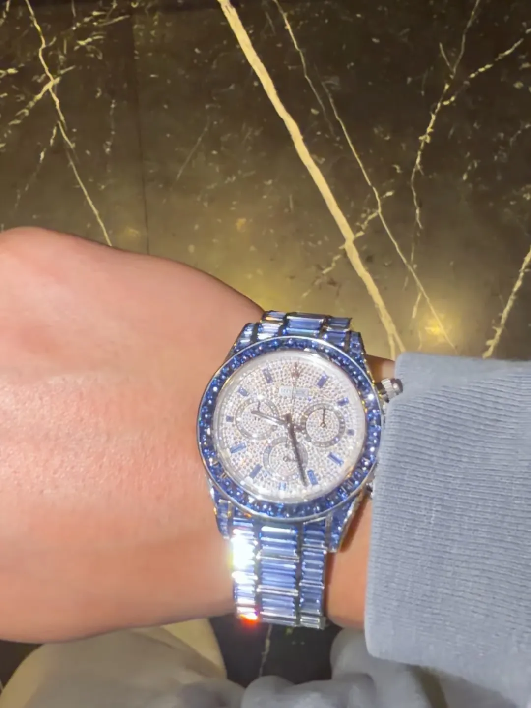 A Drake Rolex watch with diamonds and blue sapphires.