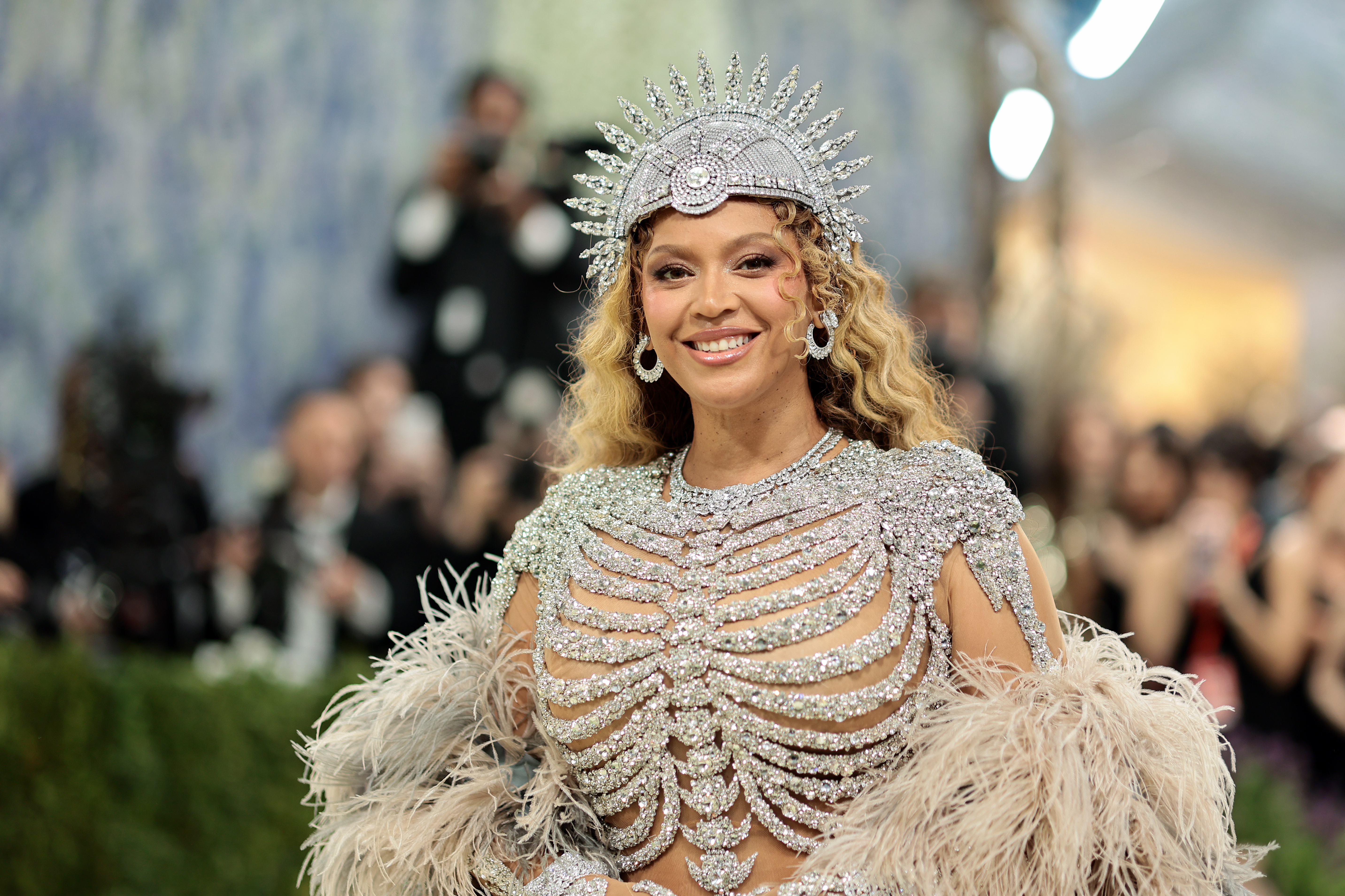 Beyoncé in a sparkling, ornate jeweled gown and crown at the Met Gala.