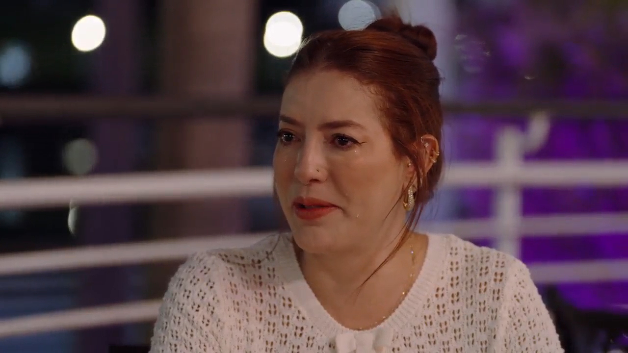 Paula crying with tears streaming down her face.