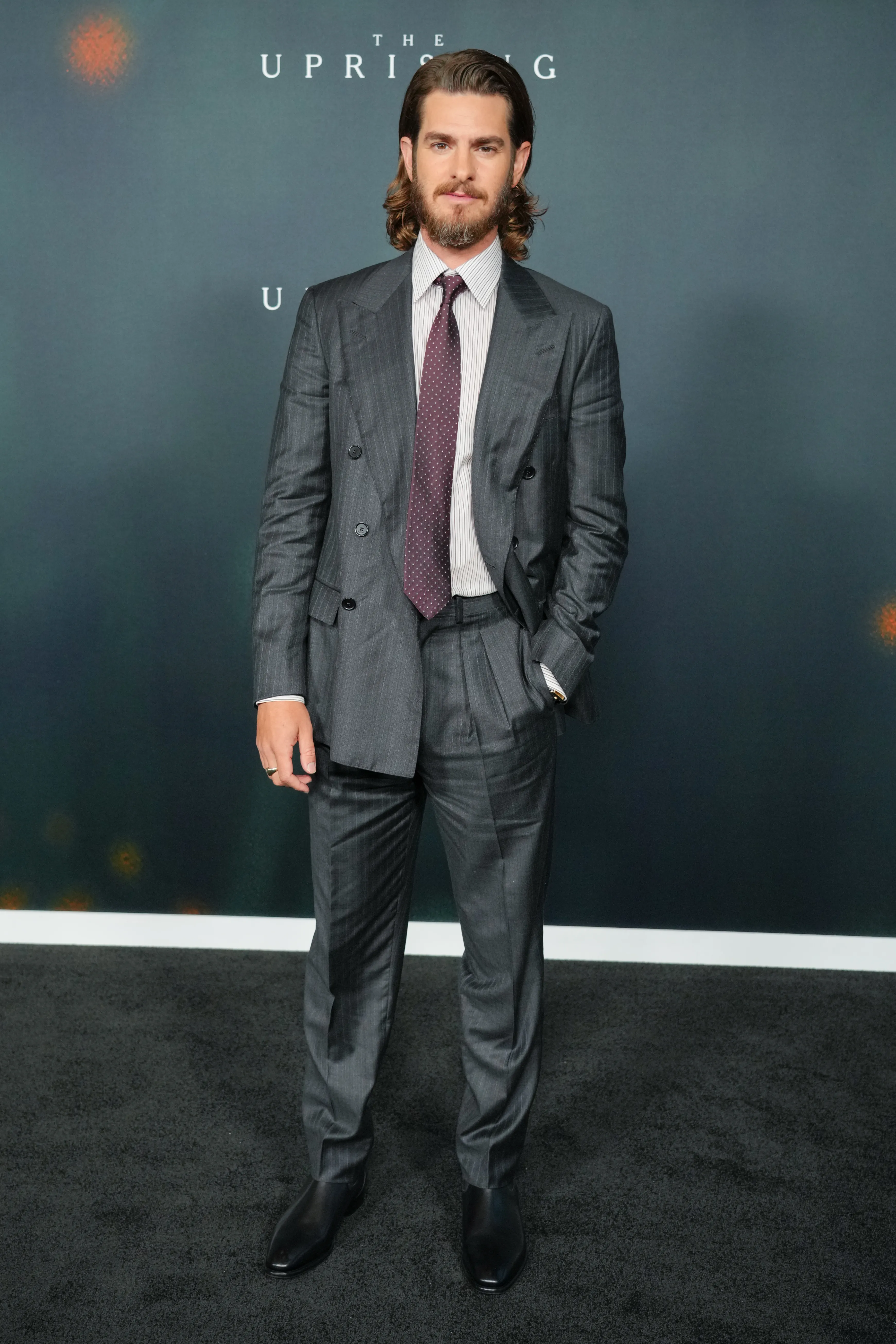 Andrew Garfield at "The Uprising" premiere in a pinstriped suit.