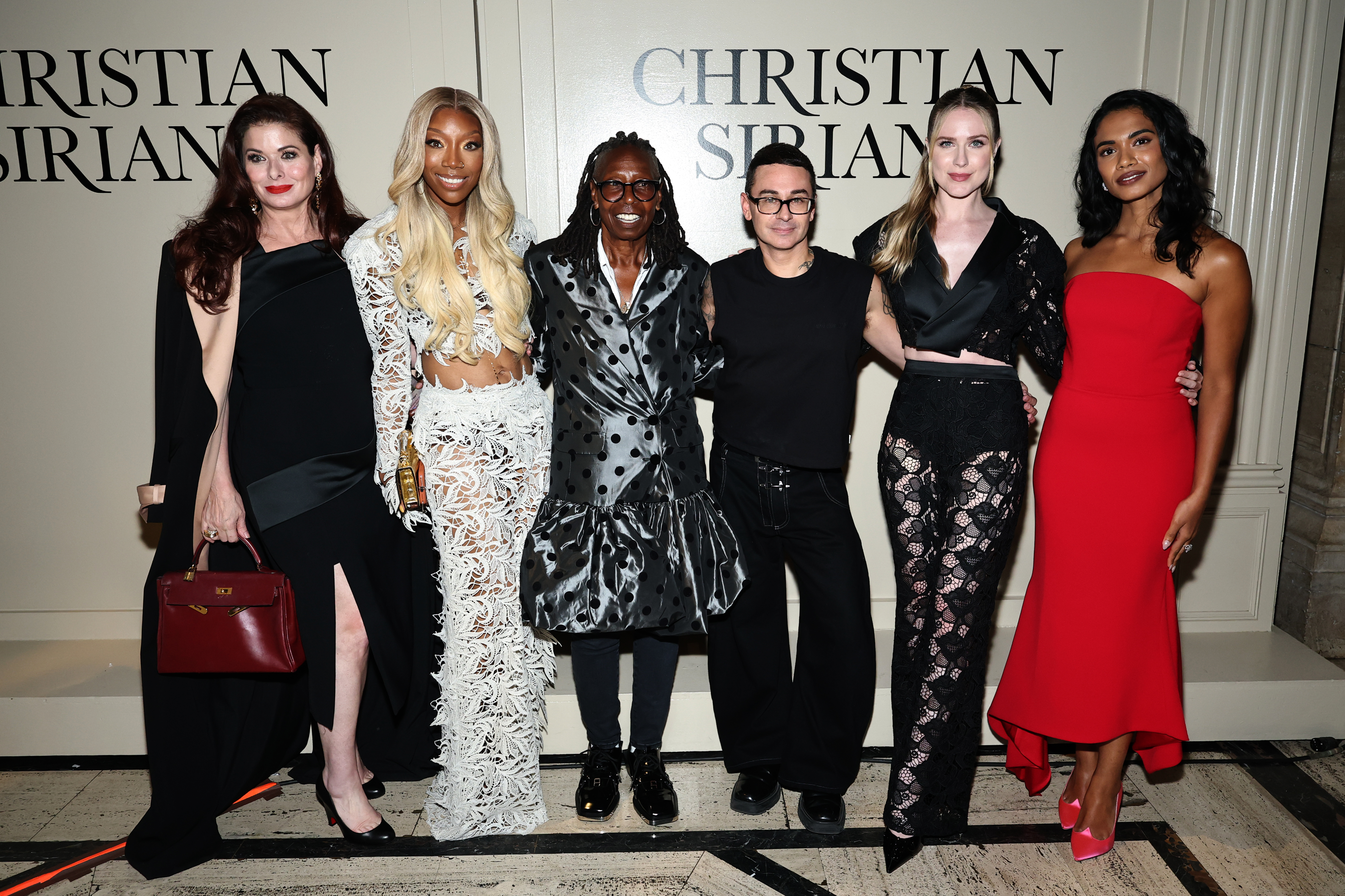 Debra Messing, Brandy Norwood, Whoopi Goldberg, Christian Siriano, Evan Rachel Wood, and Supriya Ganesh pose together.