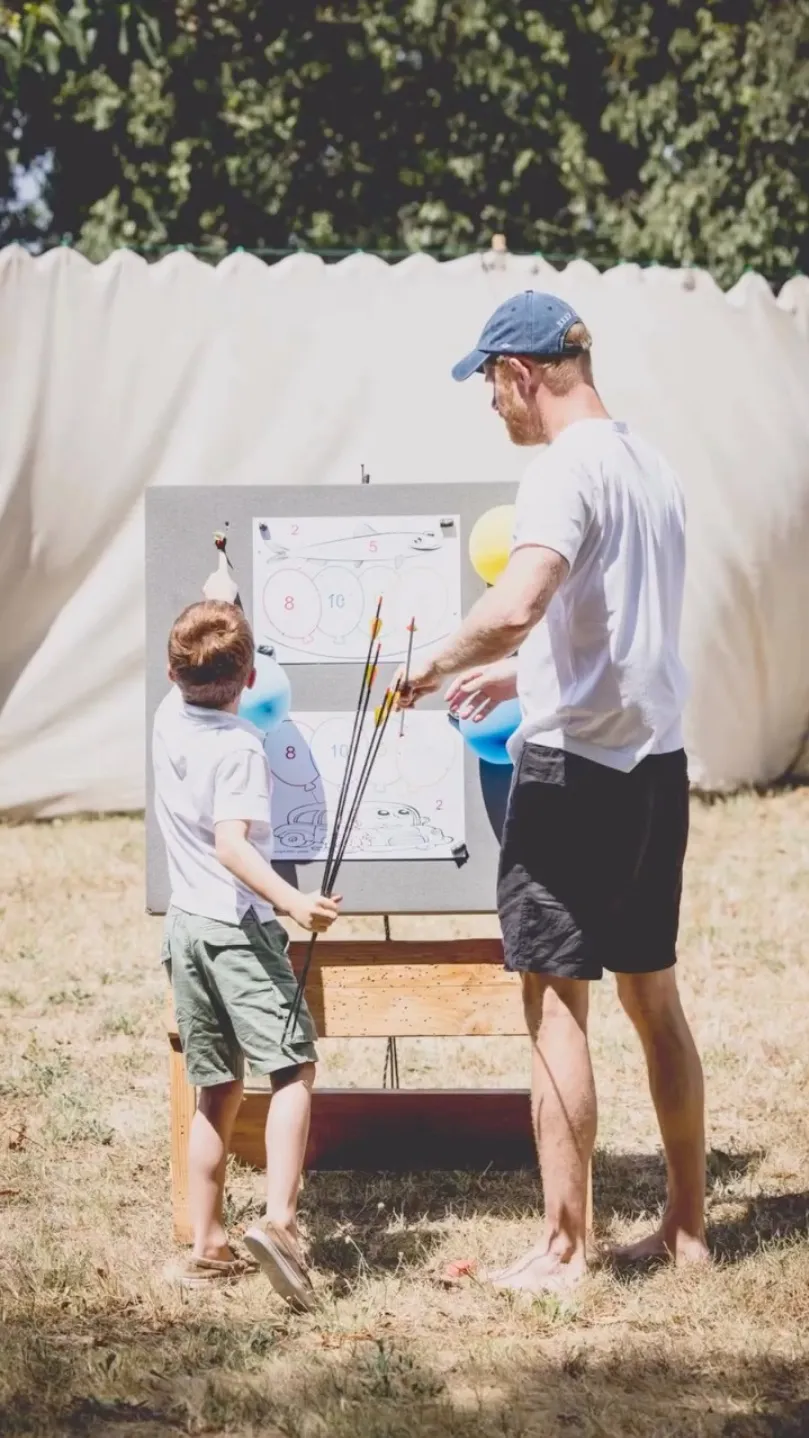 Prince Harry and Prince Archie doing archery together.