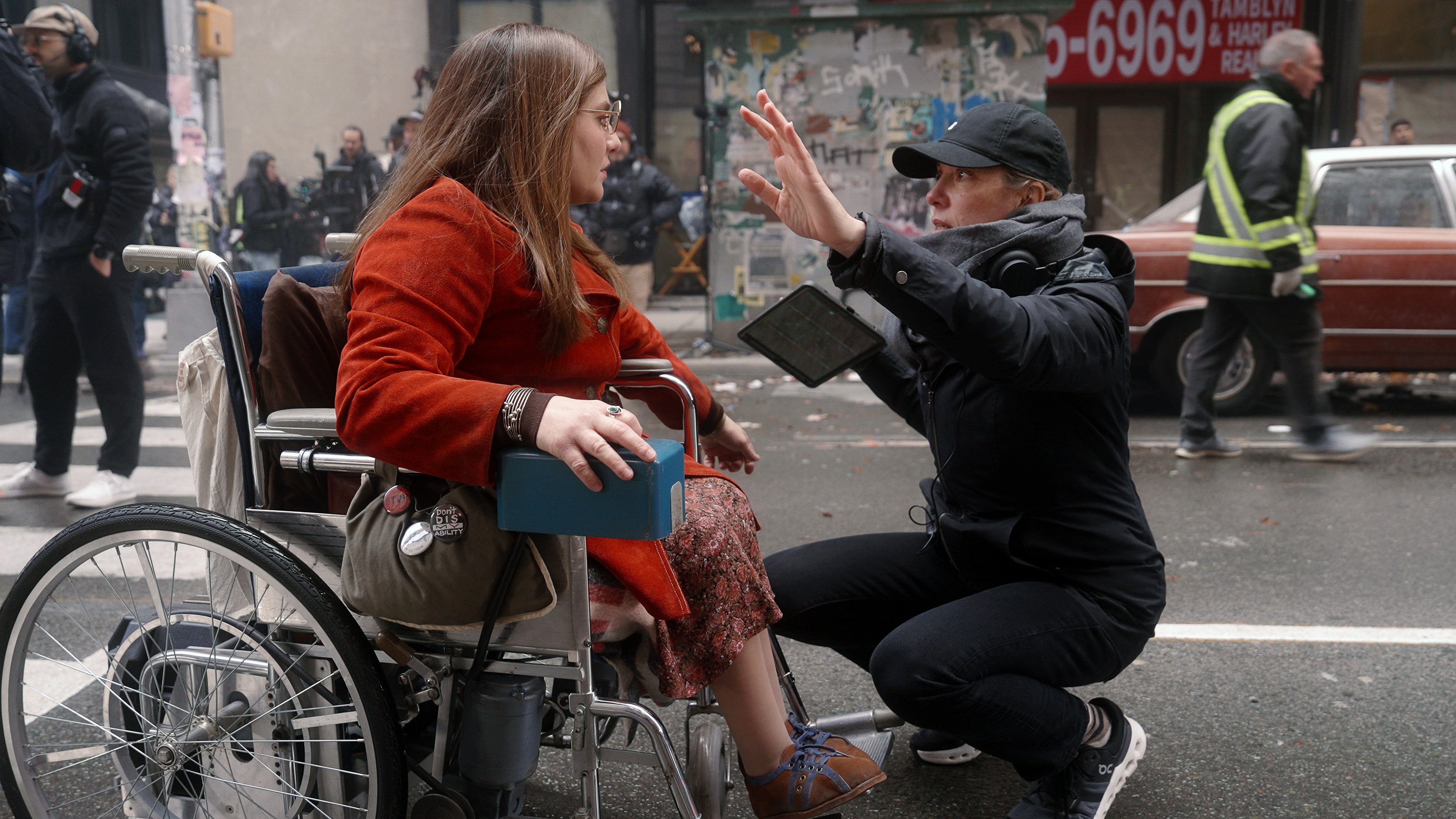 Ruth Madeley in a wheelchair, left, with director Siân Heder, right, during the filming of "Being Heumann."